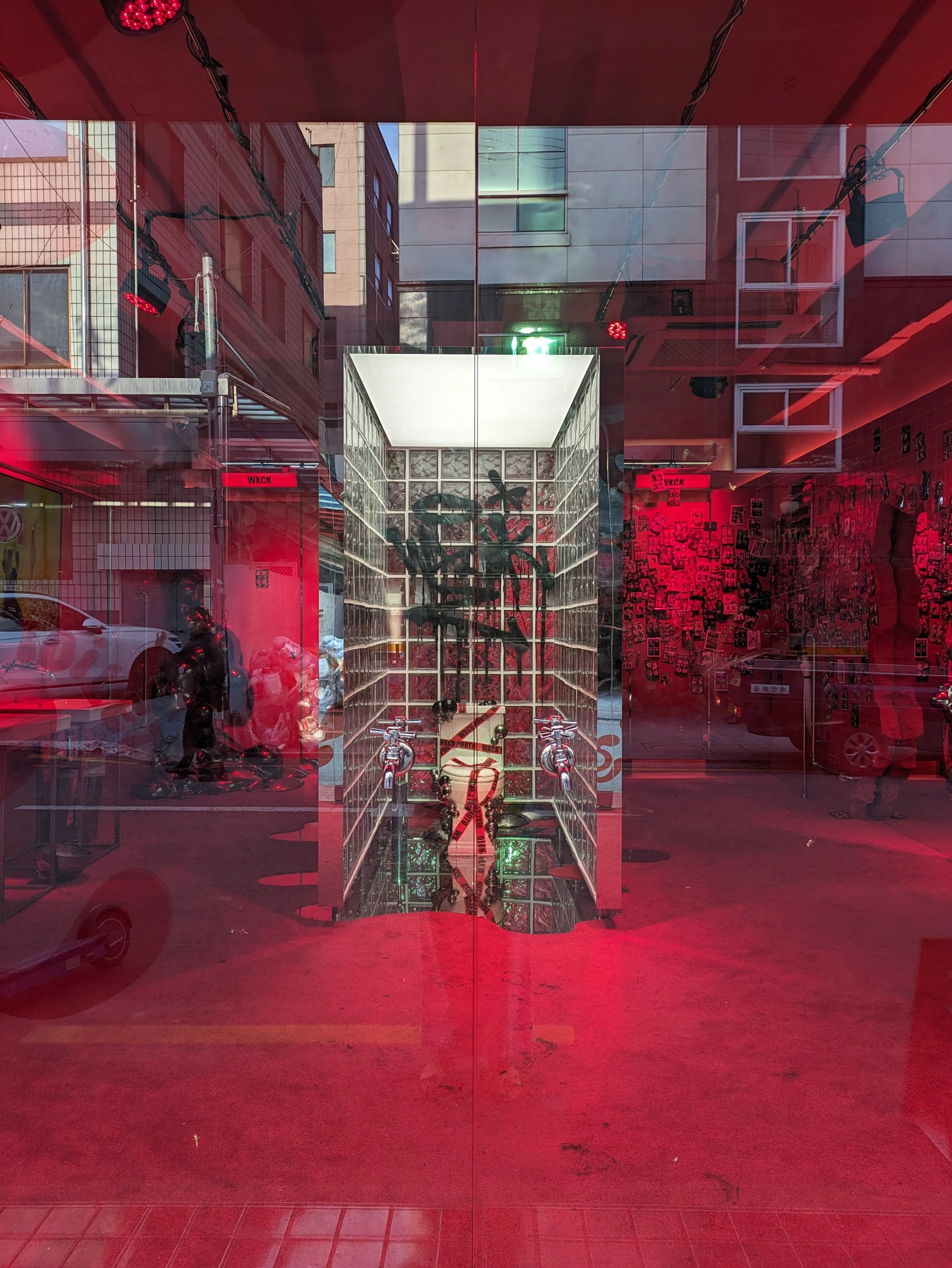 Building with many windows and pink light.