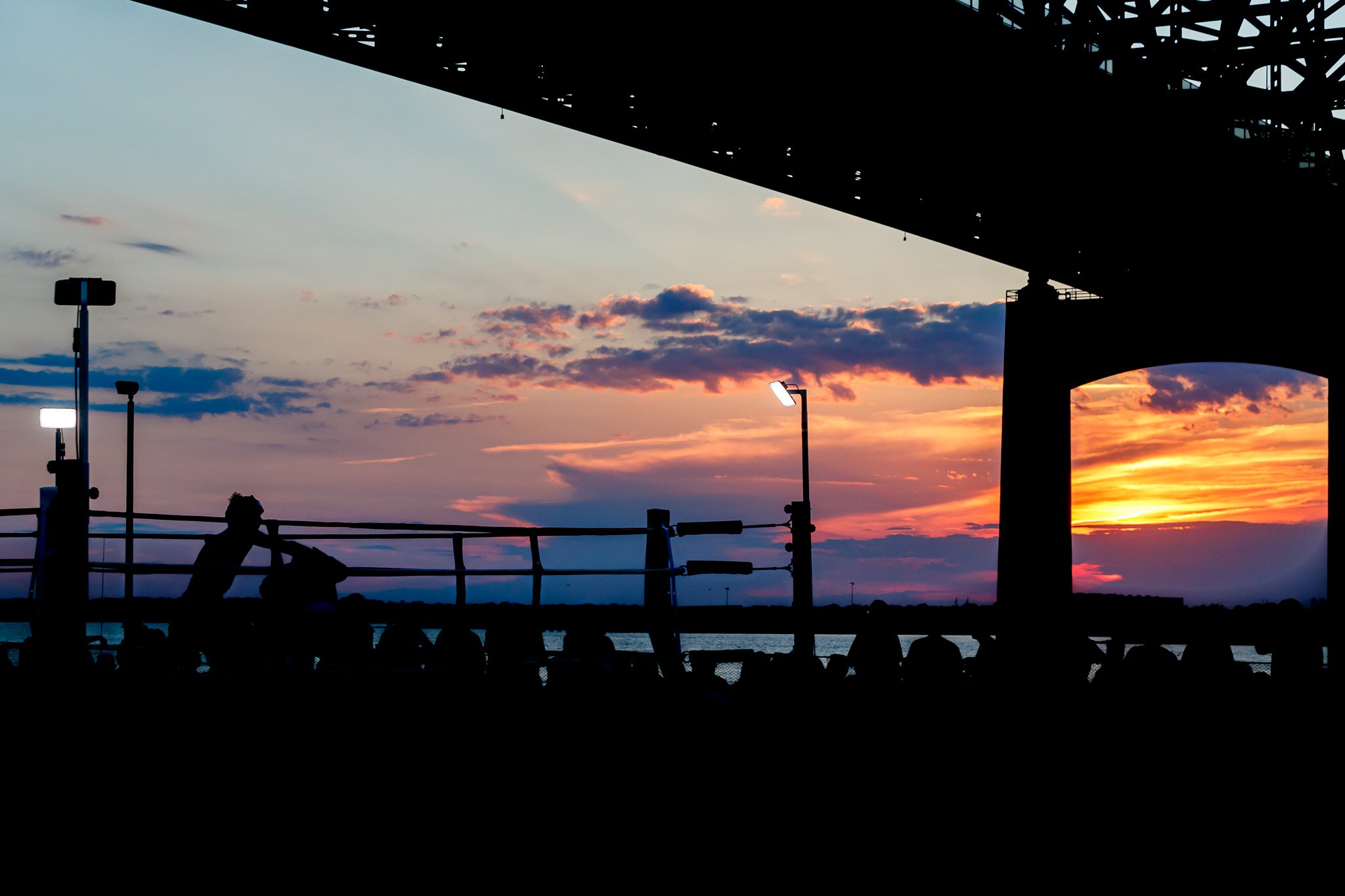 The sun sets on a boxing match atop the USS Massachusetts at Battle on a Battleship on August 20, 2022. Shot for The Fall River Herald.