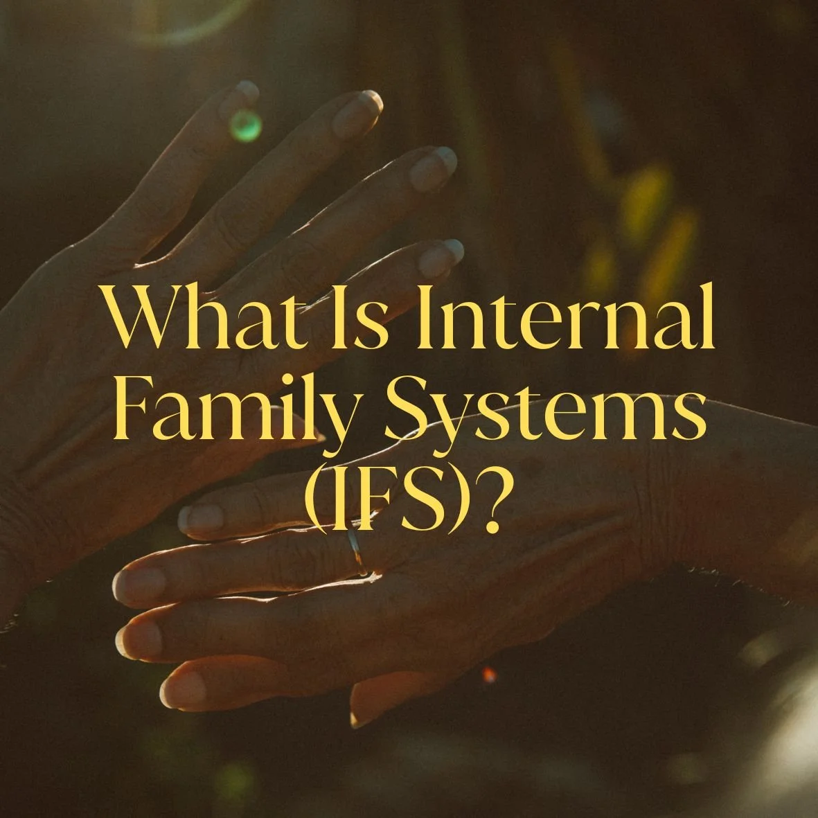 Close-up of two hands with one hand above the other, overlaid with text 'What Is Internal Family Systems (IFS)?'