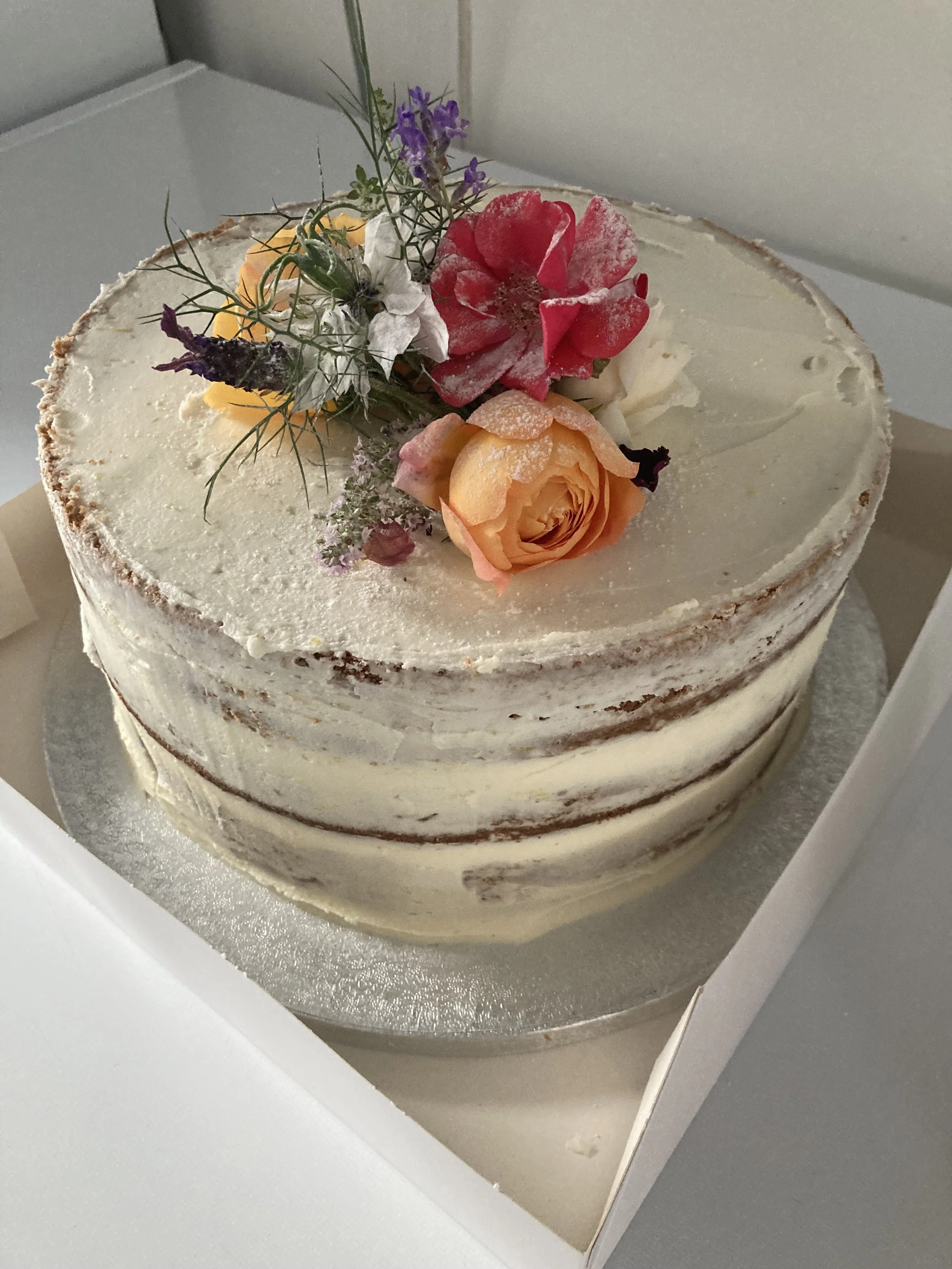 Naked tier cake with fresh flowers.
