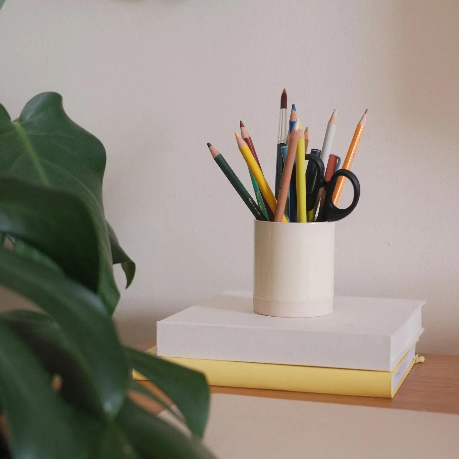 Creative planning desk with pencils and sketchbooks at EmBr Studio.