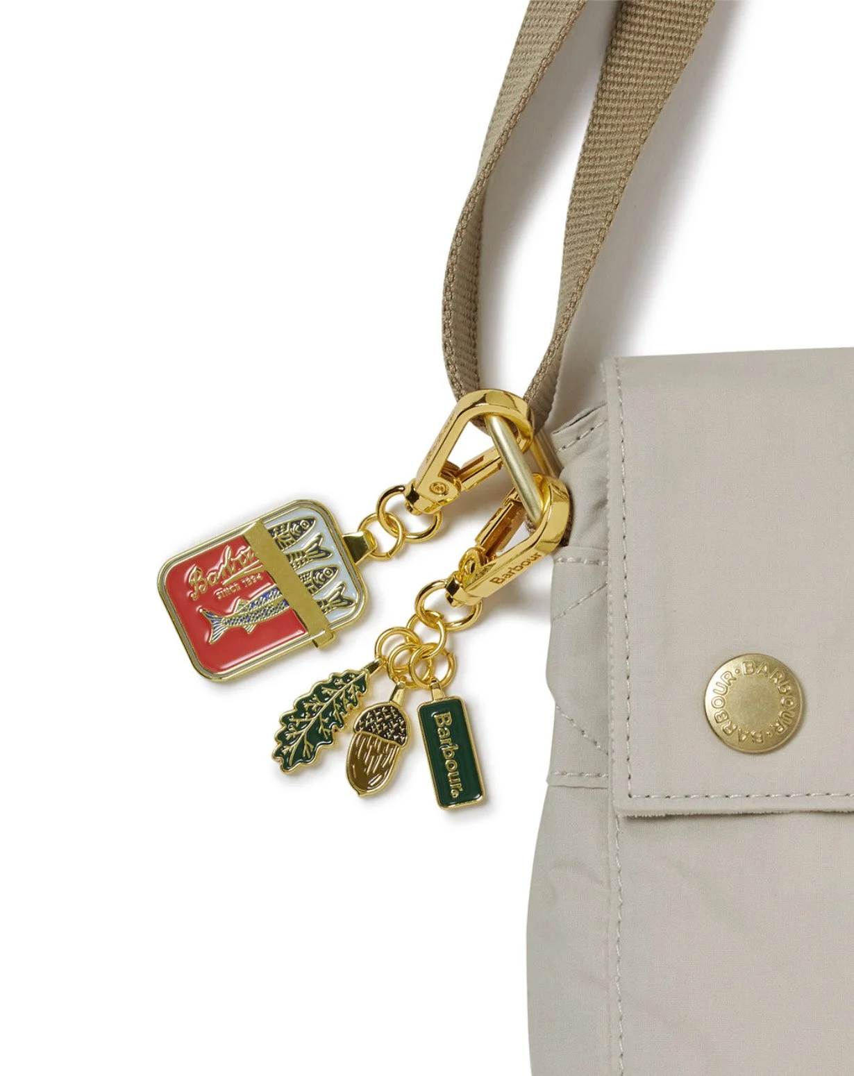 Barbour enamel keyring with heritage-inspired charms attached to a jacket pocket