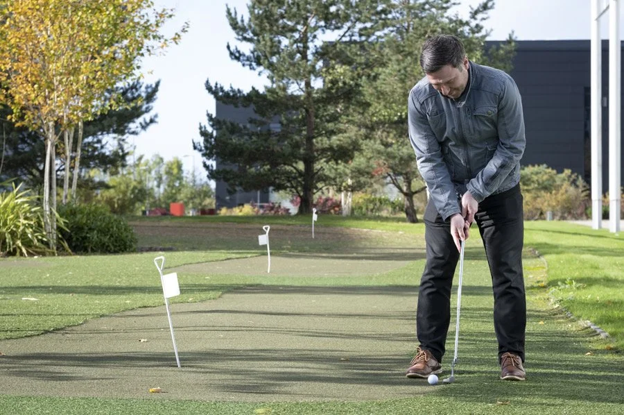 Man playing golf at the putting green