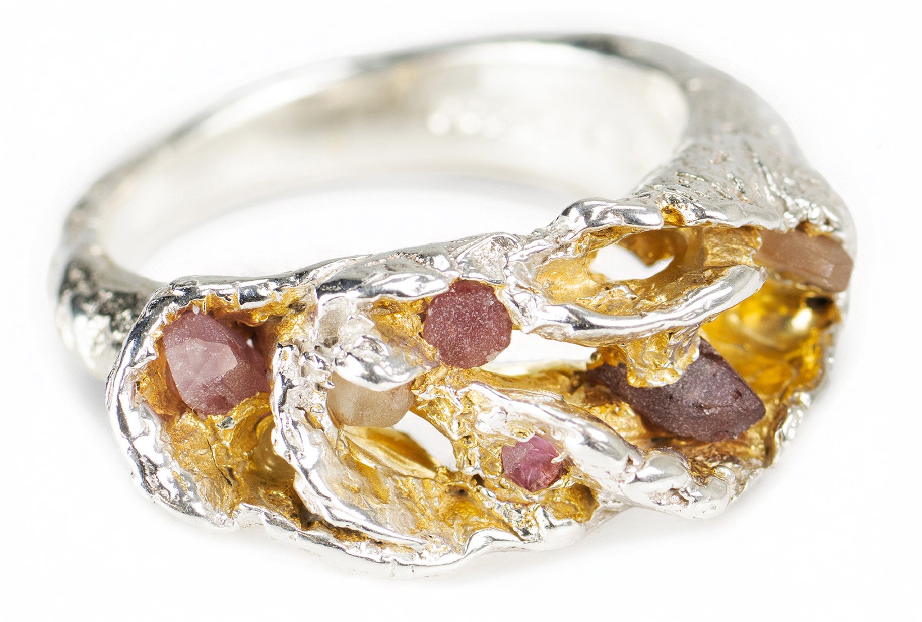 Sculptural silver and gold ring with organic textures and rough pink and purple sapphires