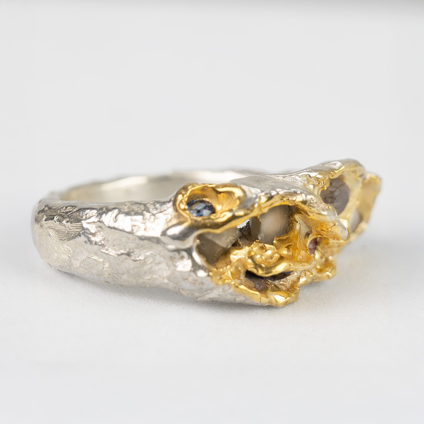 Deep textuerd Beneath the surface Silver and multiple raw and faceted sapphire ring.jpg