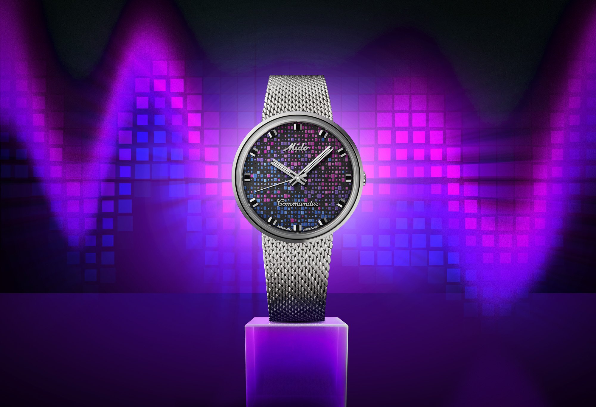 Montre Mido Commander à cadran mosaïque coloré sur fond violet, packshot horloger à Neuchâtel