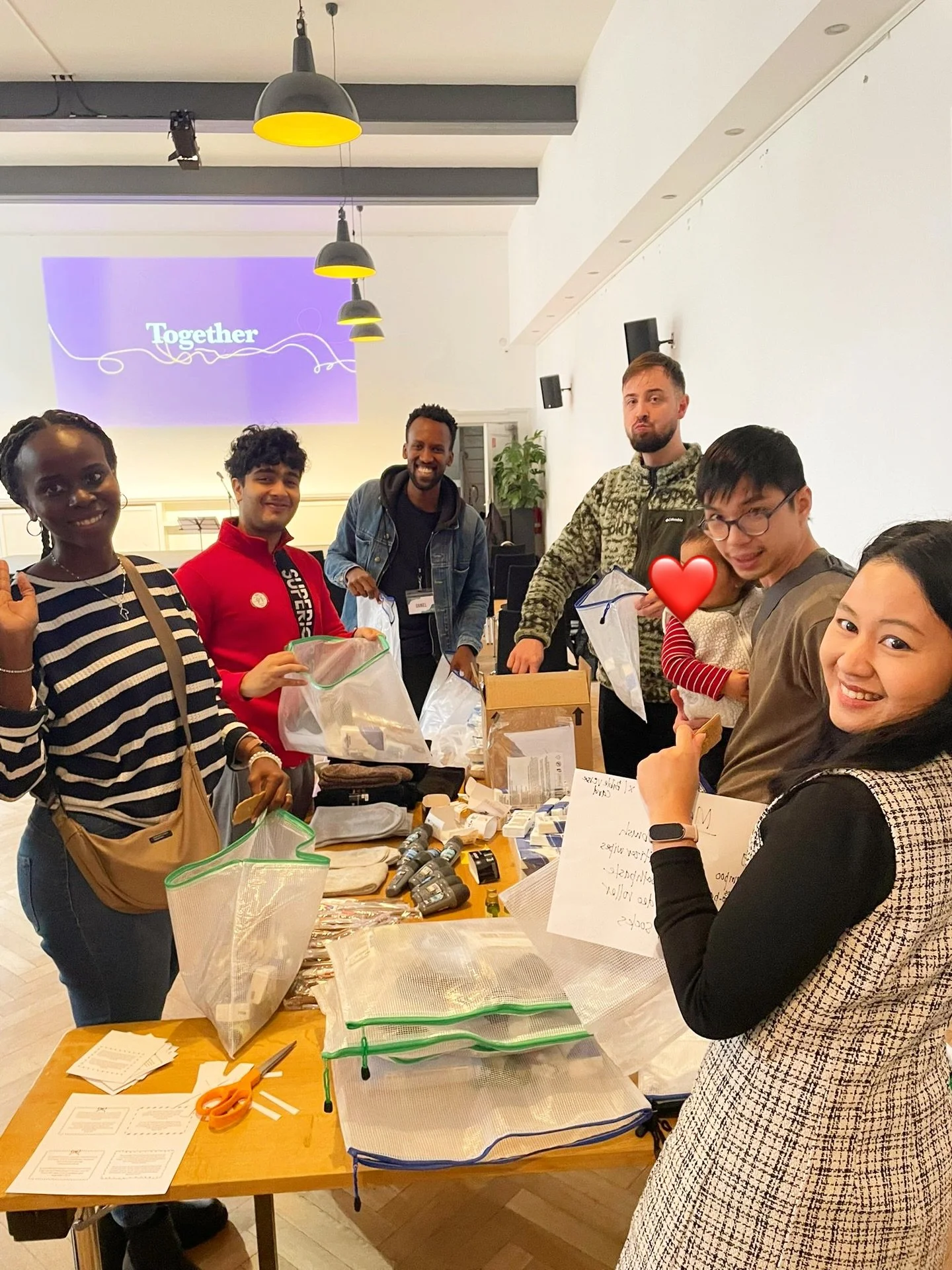 Volunteers at our Berlin church preparing hygiene bags for the homeless, representing one of the active churches in Berlin Germany.