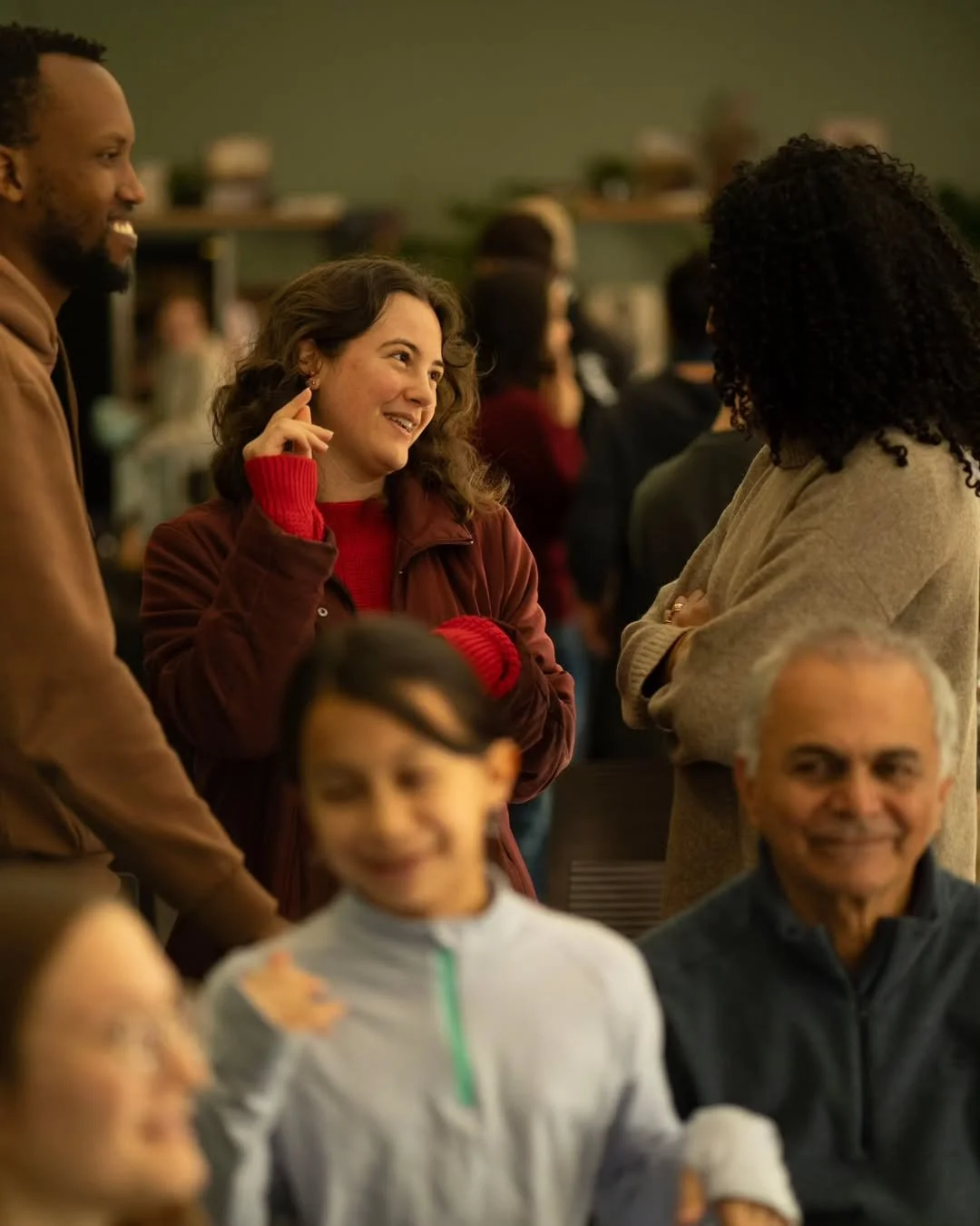 Church members, including a woman in a red sweater, socializing during a community lunch at our English-speaking church Berlin.
