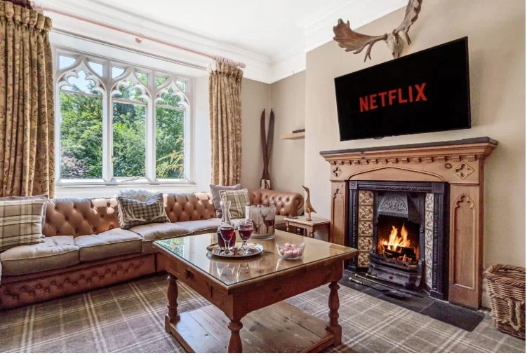 Lake District Women's Yoga Retreat accommodation living room with cosy sofas and log fire