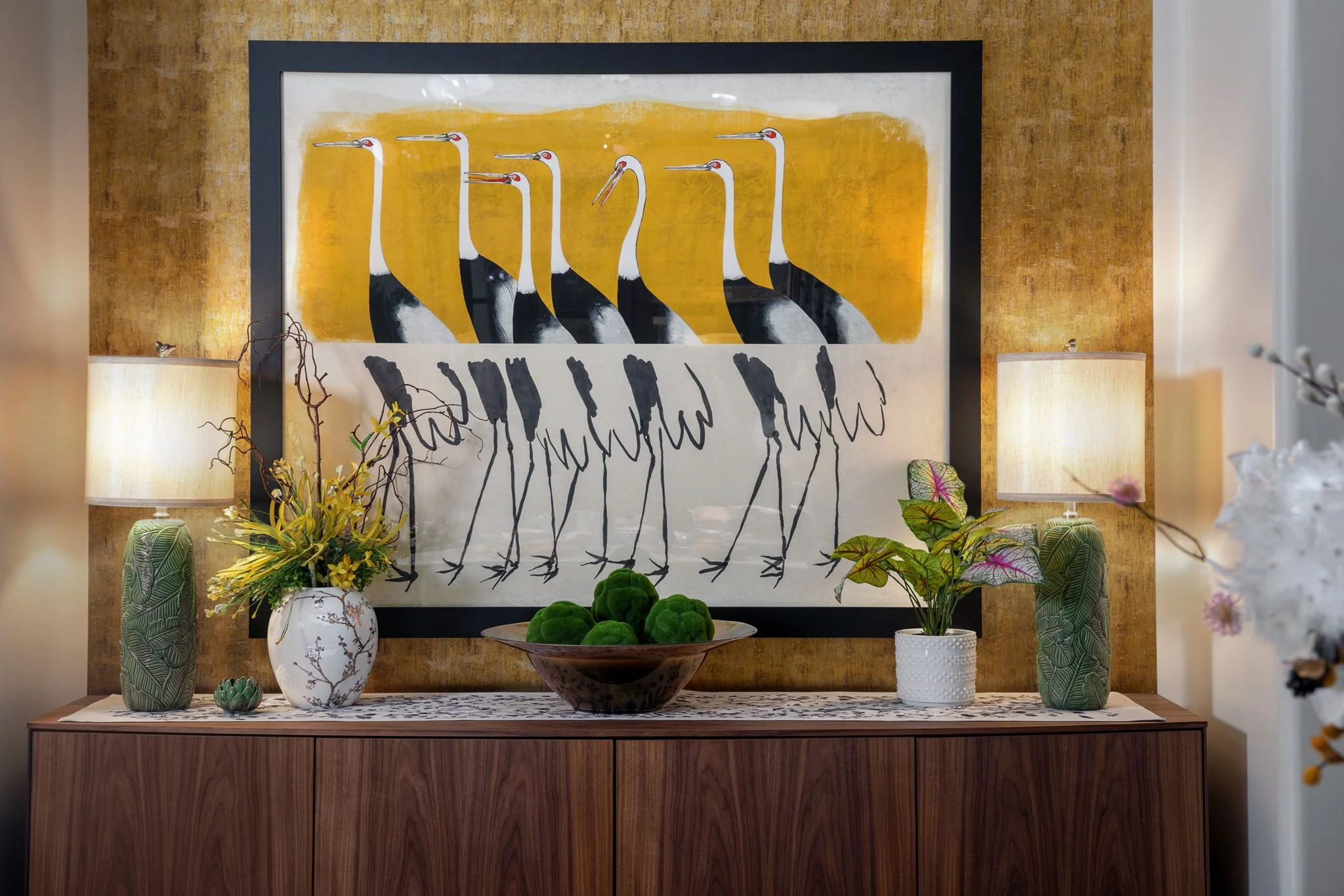 Dining room sideboard featuring crane artwork and gold grasscloth wallpaper, a Red Carrot Design project in Superstition Mountain, Gold Canyon, AZ.