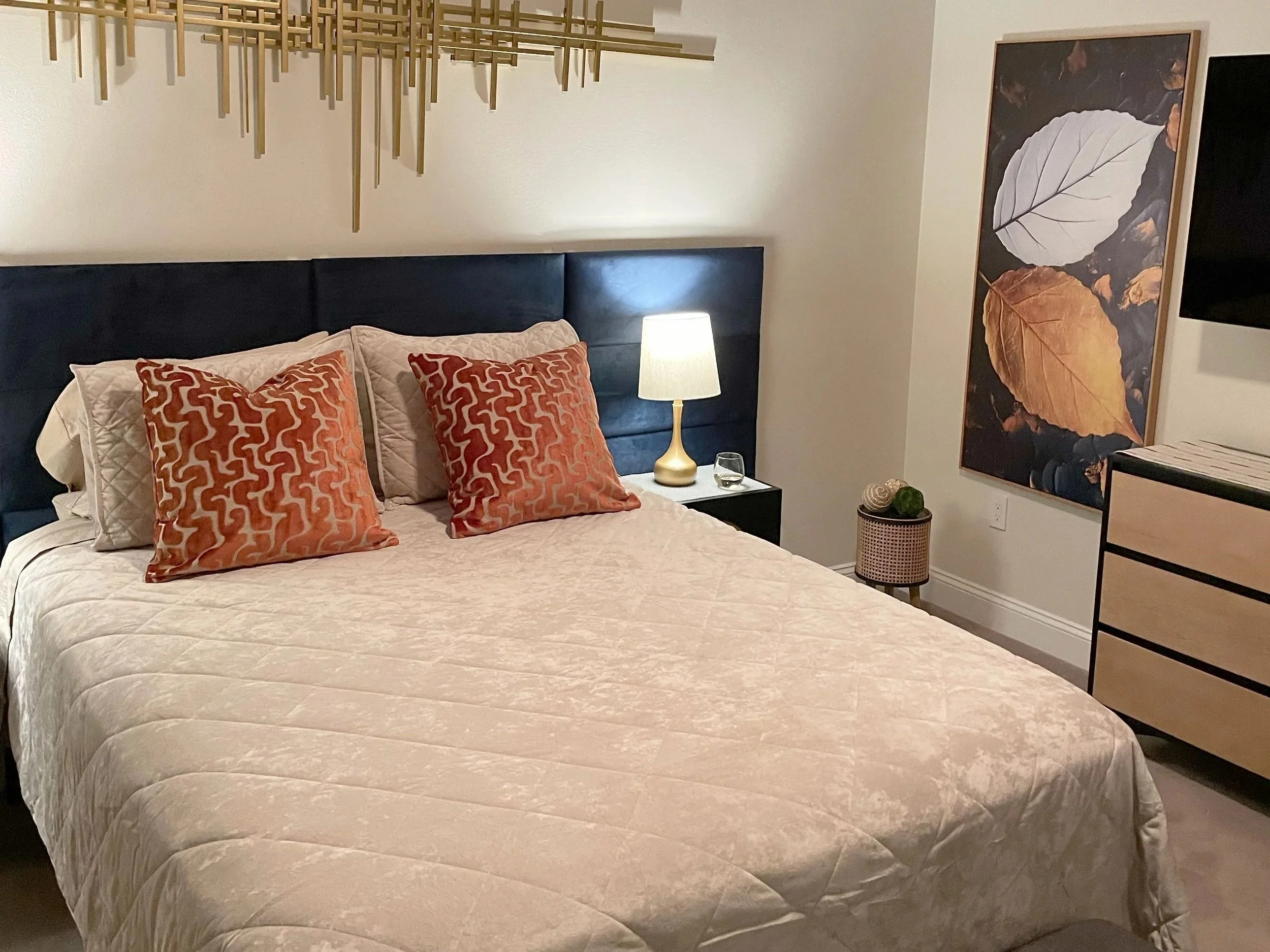 Luxury guest bedroom interior styling with neutral linens and an accent chair