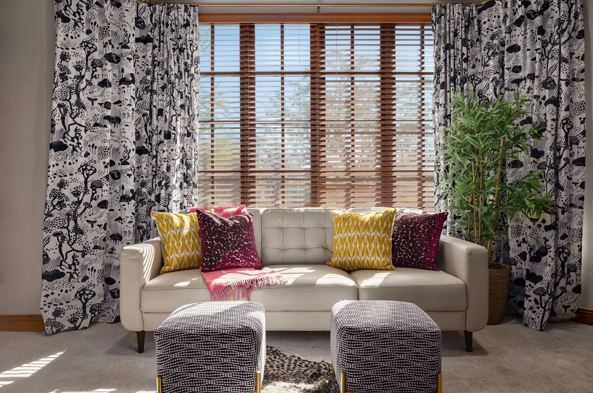 Sophisticated bedroom sitting area with custom window treatments and colorful textured pillows, a Red Carrot Design project in Gold Canyon, AZ.