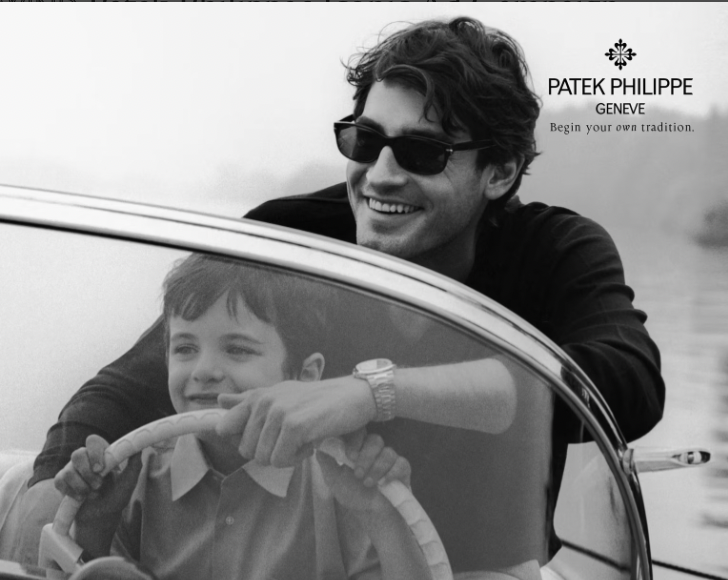 Black-and-white Patek Philippe advertisement showing a smiling father wearing a luxury watch guiding his young son steering a boat, symbolizing heritage and generational legacy.