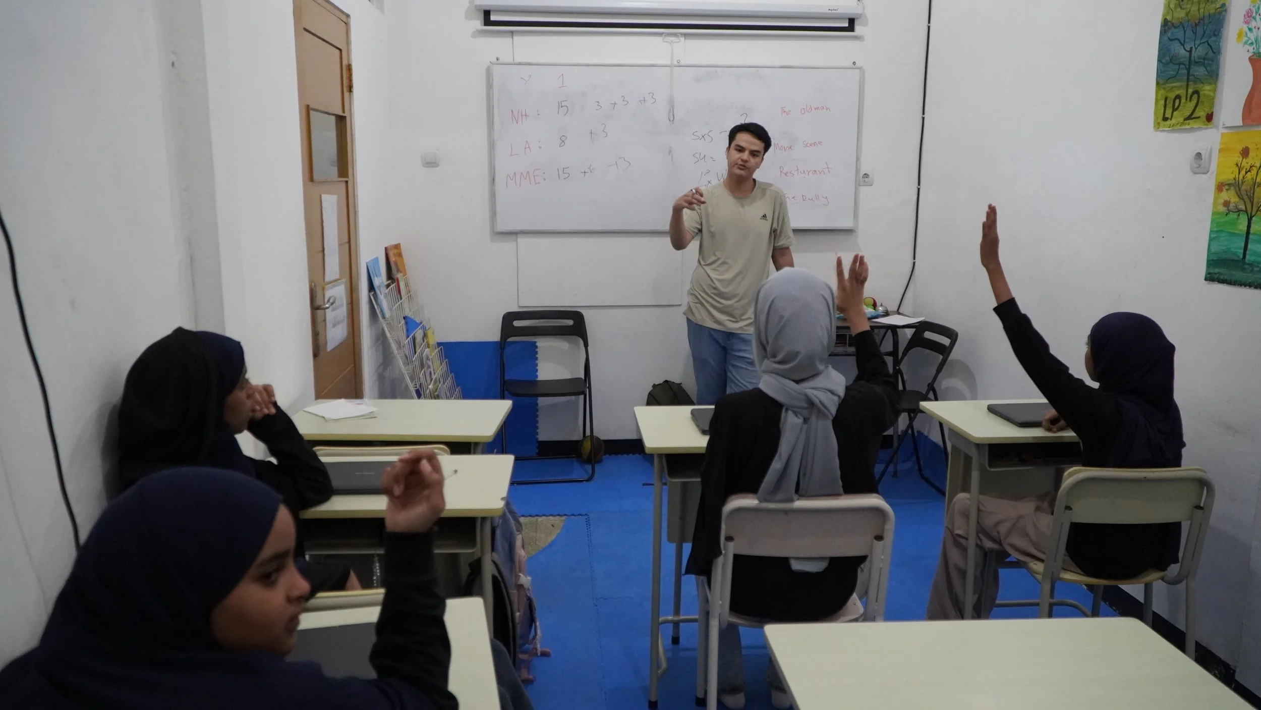 2025 EOS - Teacher Shohaib explaining.JPG