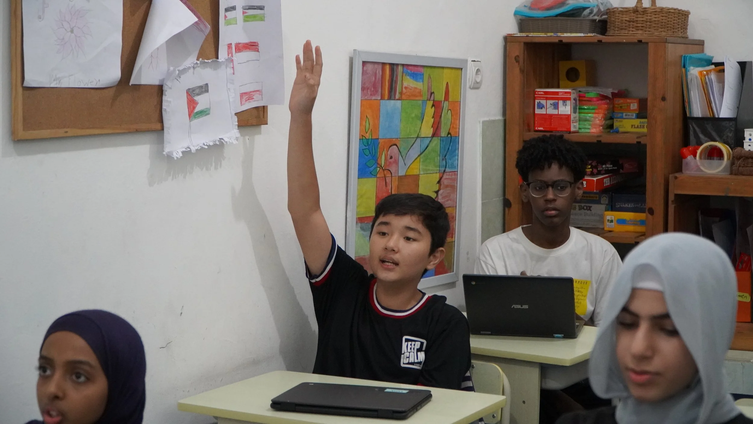 2025 EOS Class - Student raising had.JPG