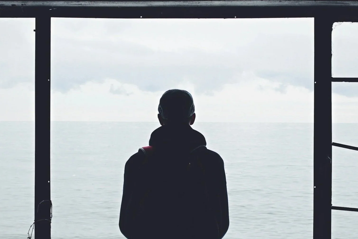 mariner standing alone on ship deck experiencing isolation during long tour
