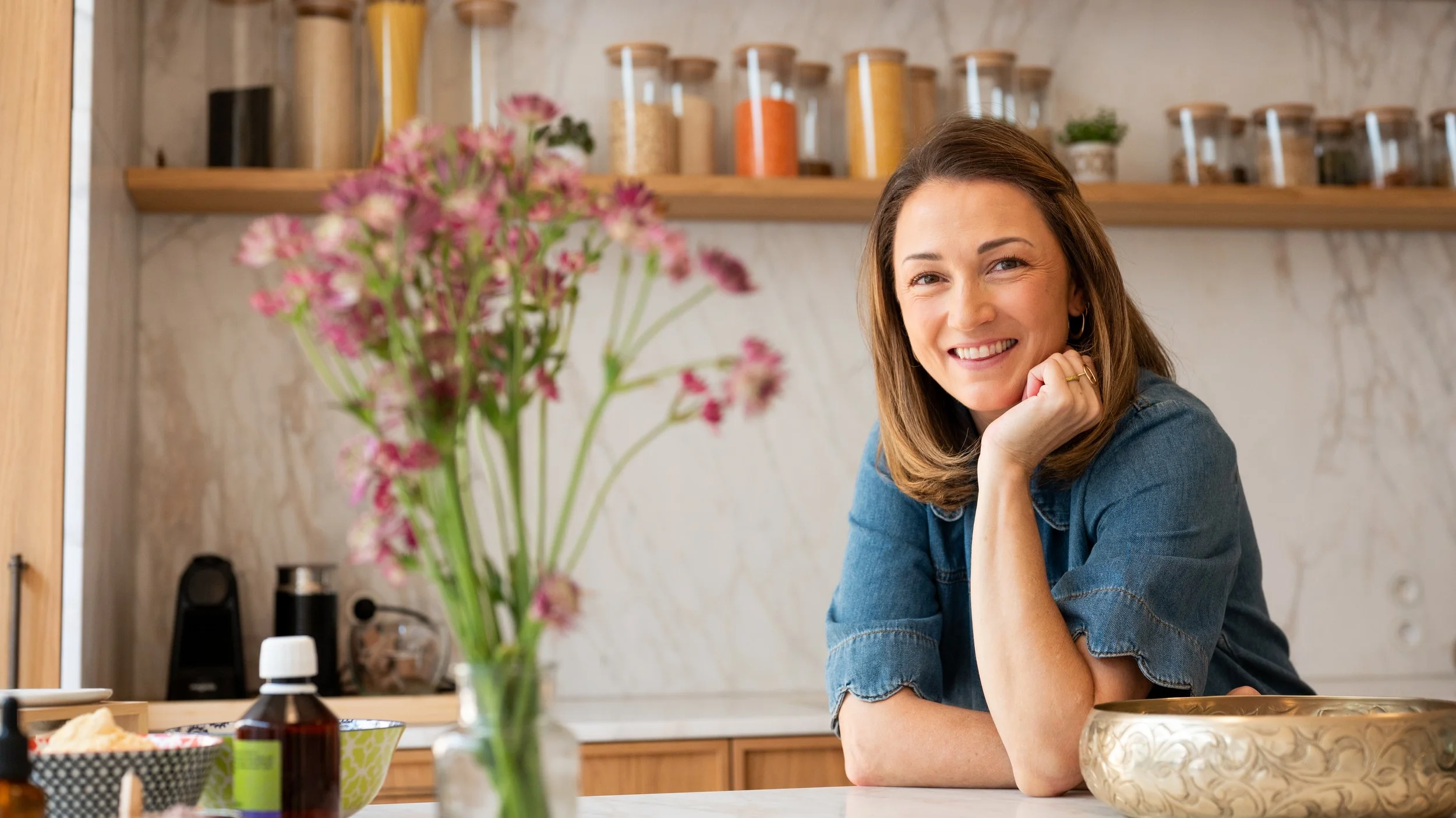 Lindsay Roberts in her kitchen, surrounded by Ayurvedic herbs and oils