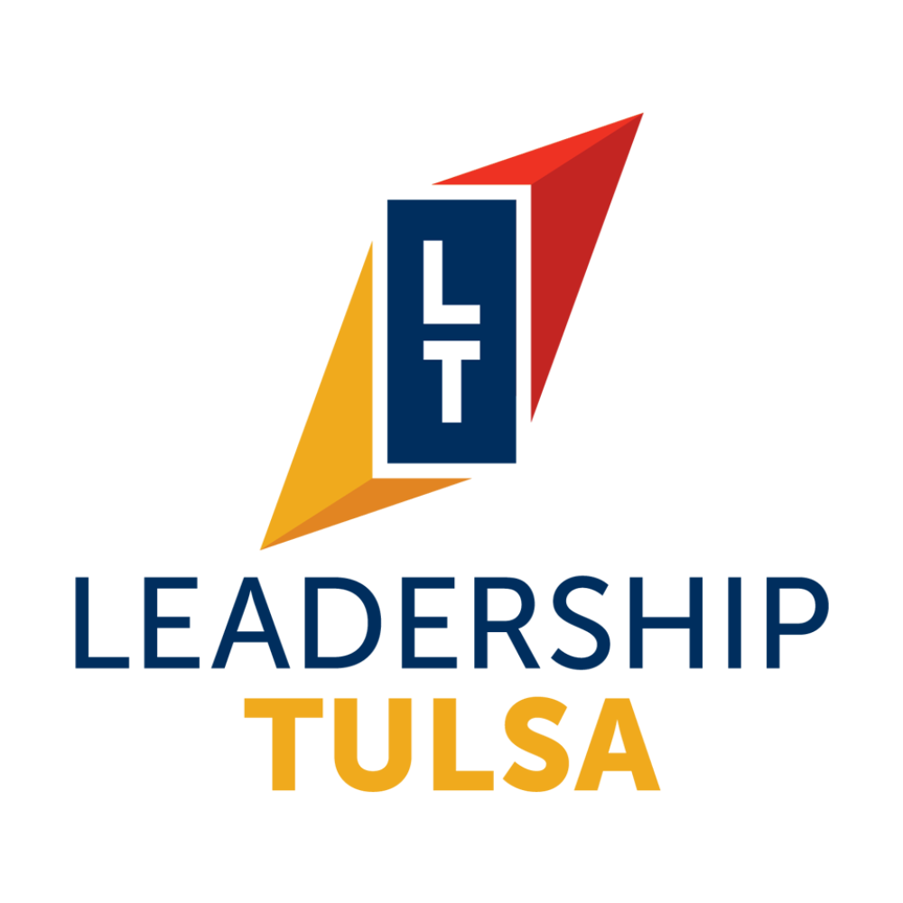 Logo with the words "Leaders USA" and a dark blue square containing the letters "L" and "T" above the word "LEADERS" in large dark blue letters and "USA" in smaller yellow letters, with a red arrow pointing upward behind them.