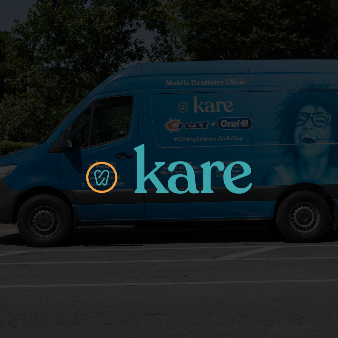 Blue mobile dentistry clinic van with 'Kare' logo, a smiling woman with glasses photo, and logos of Crest, Oral-B, and other dental brands.
