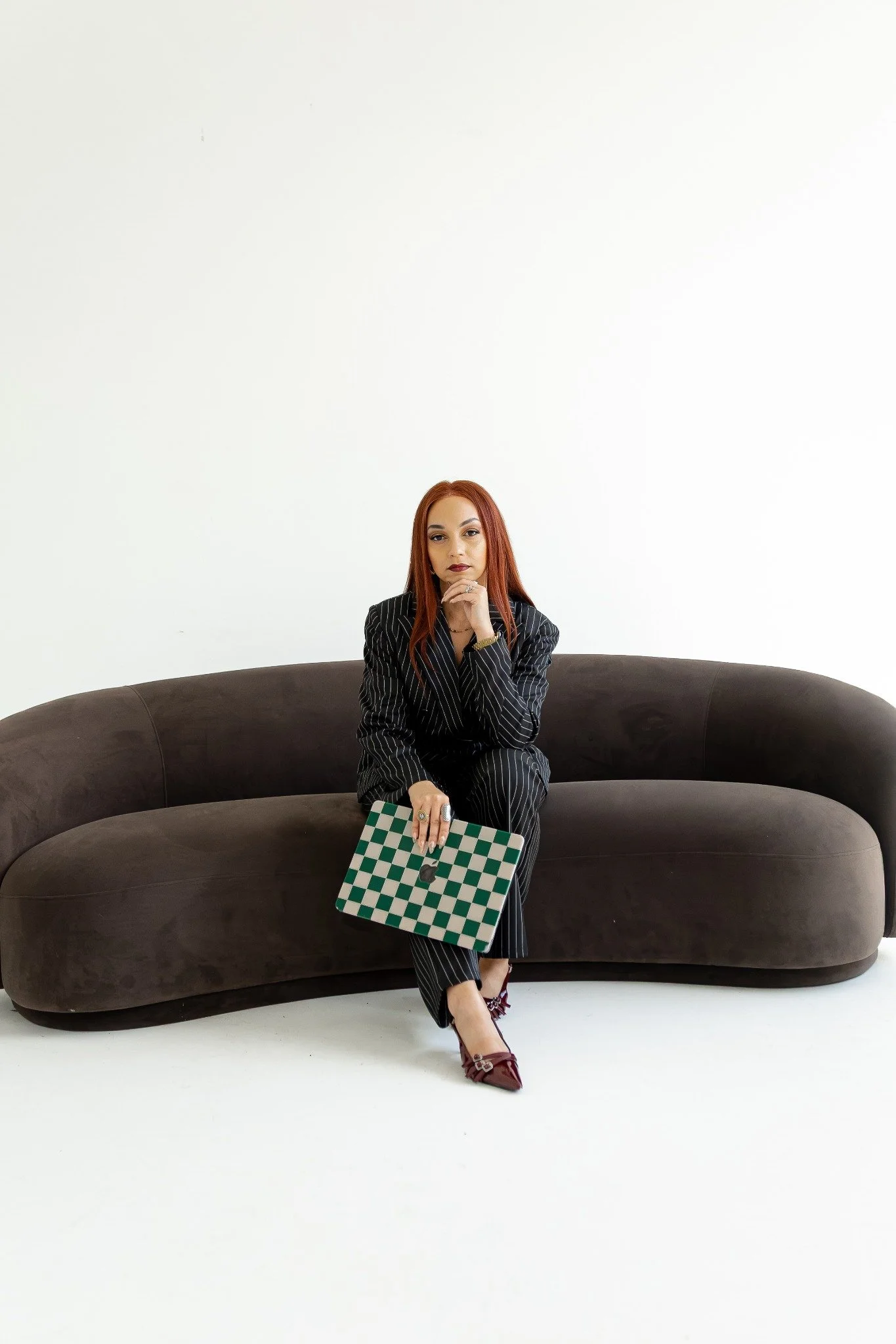 Ivanna Price, founder of The Social Bar Creative, seated in a brand portrait