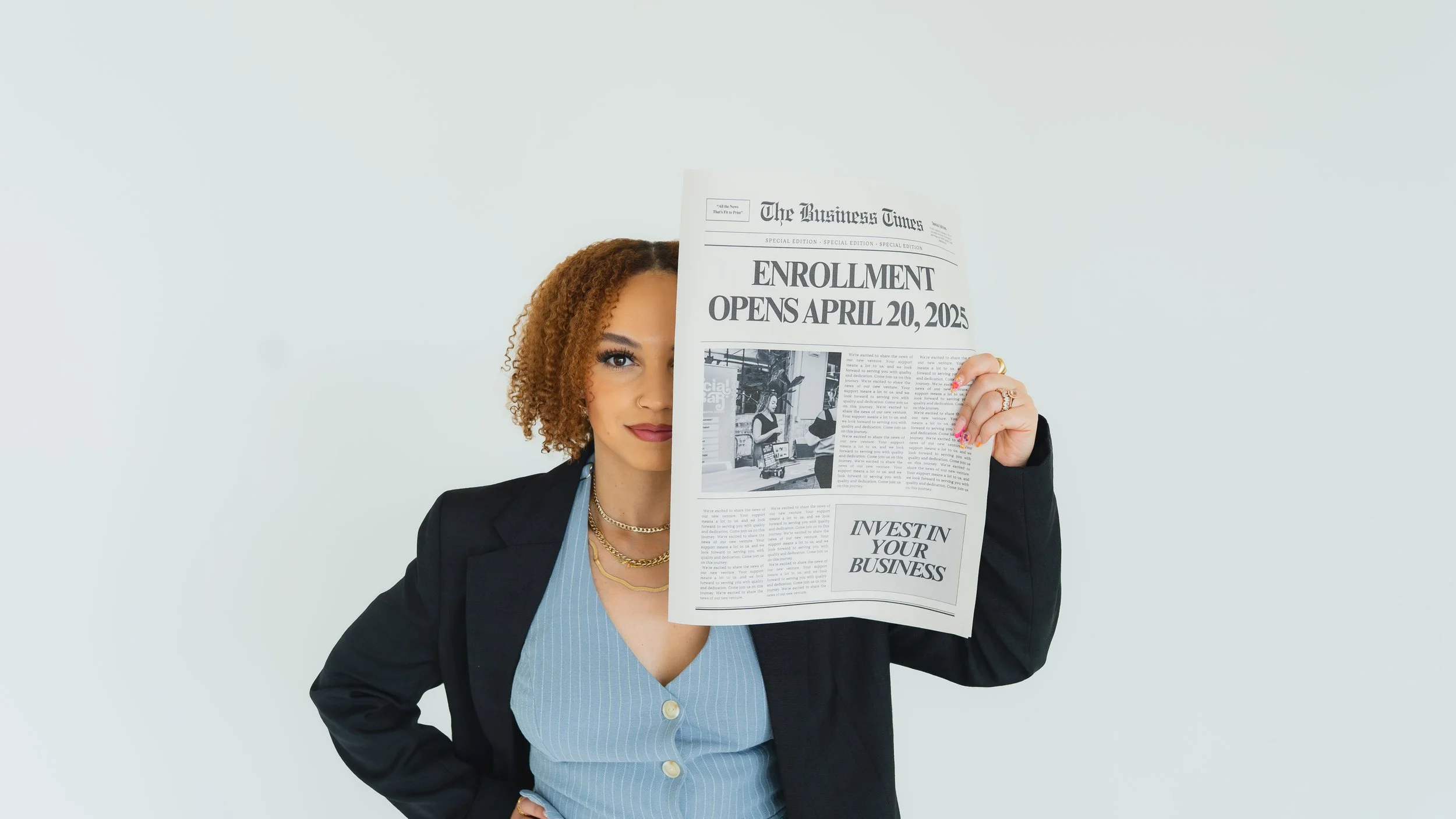 A woman with curly hair, wearing a black blazer and blue shirt, holding a newspaper titled 'The Business Times' that says 'Enrollment Opens April 20, 2025', with her face partially obscured by the newspaper.