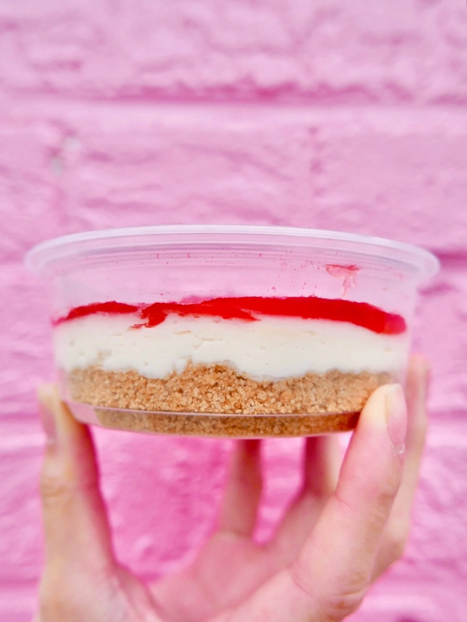 Strawberry cheesecake cream cheese‼️ Buttery graham cracker crumblies, whipped cream cheese, 🍓 jam + 🍓 dust. Eat it with a 🥄 or schmear it on some carbs if you have more self control than us.