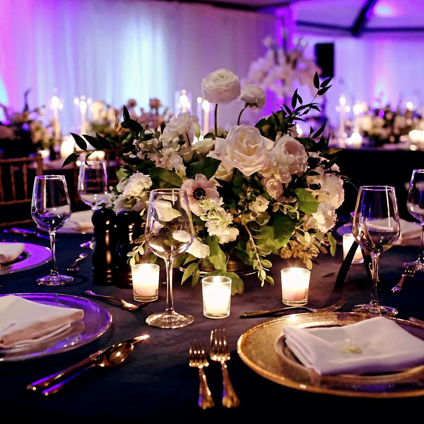 Simple and elegant can truly go a long way. If you're interested in an all white pallet for your floral design consider a beautiful colored linen to complete the look like we did here with a stunning navy velvet and gold metallics throughout. Absolut