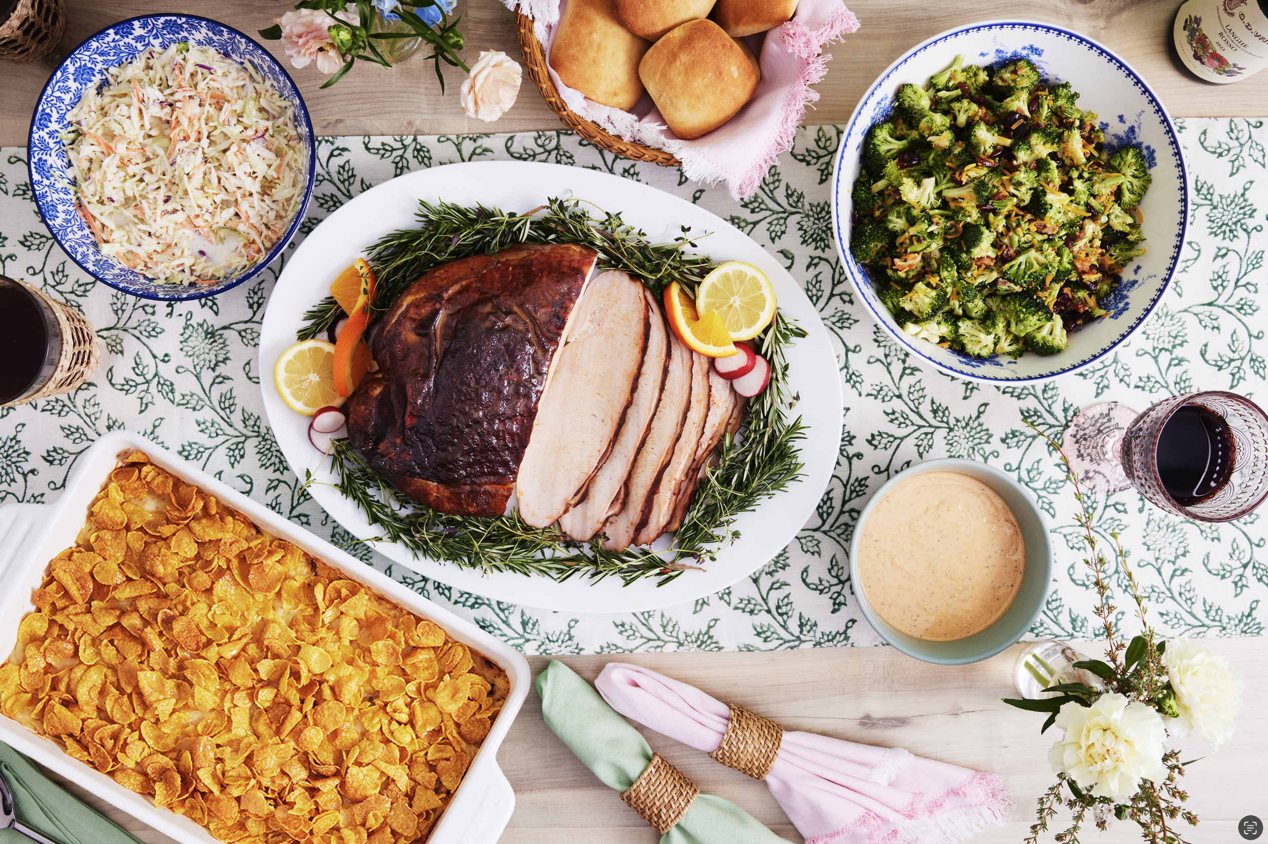 An overhead photo of an Easter supper feast, with smoked turkey, broccoli salad, and more.