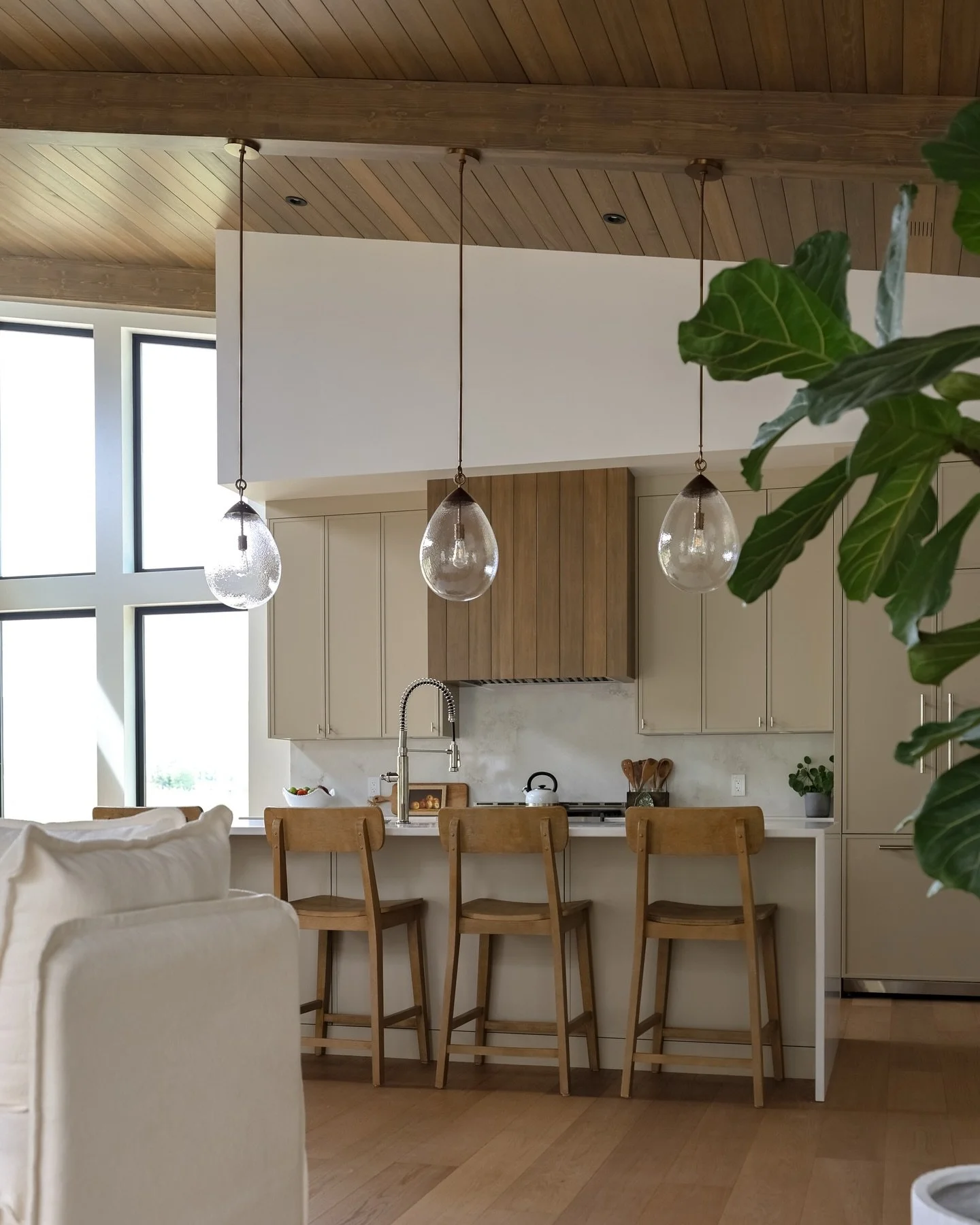 Custom kitchen details

Finished and installed faux beams and yellow cedar t&amp;g on ceiling, installed white oak hardwood floors, built and finished custom wood range hood to match the ceiling, installed cabinets and hardware. 

Cabinetry by @thewo