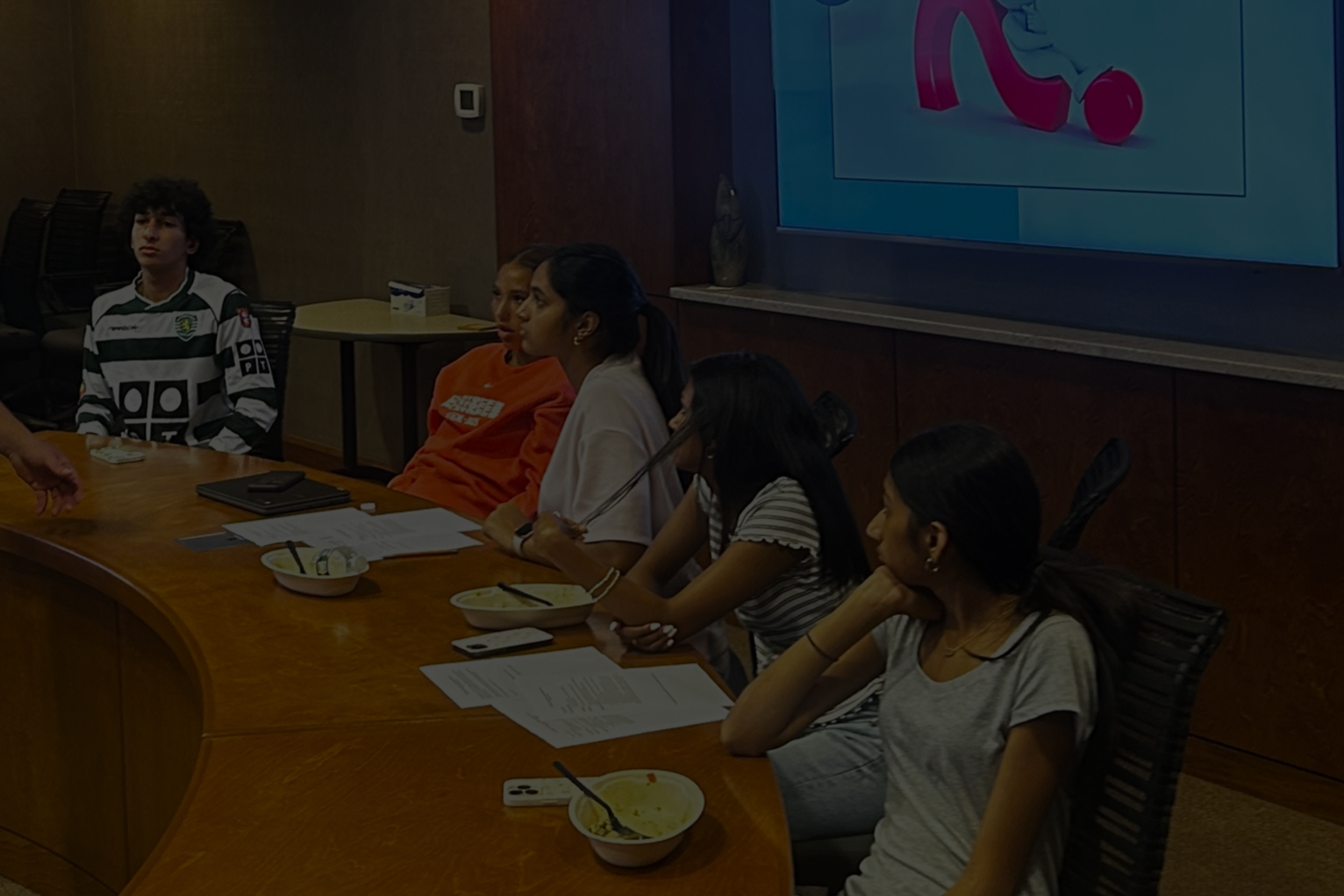 Teens sitting at conference table