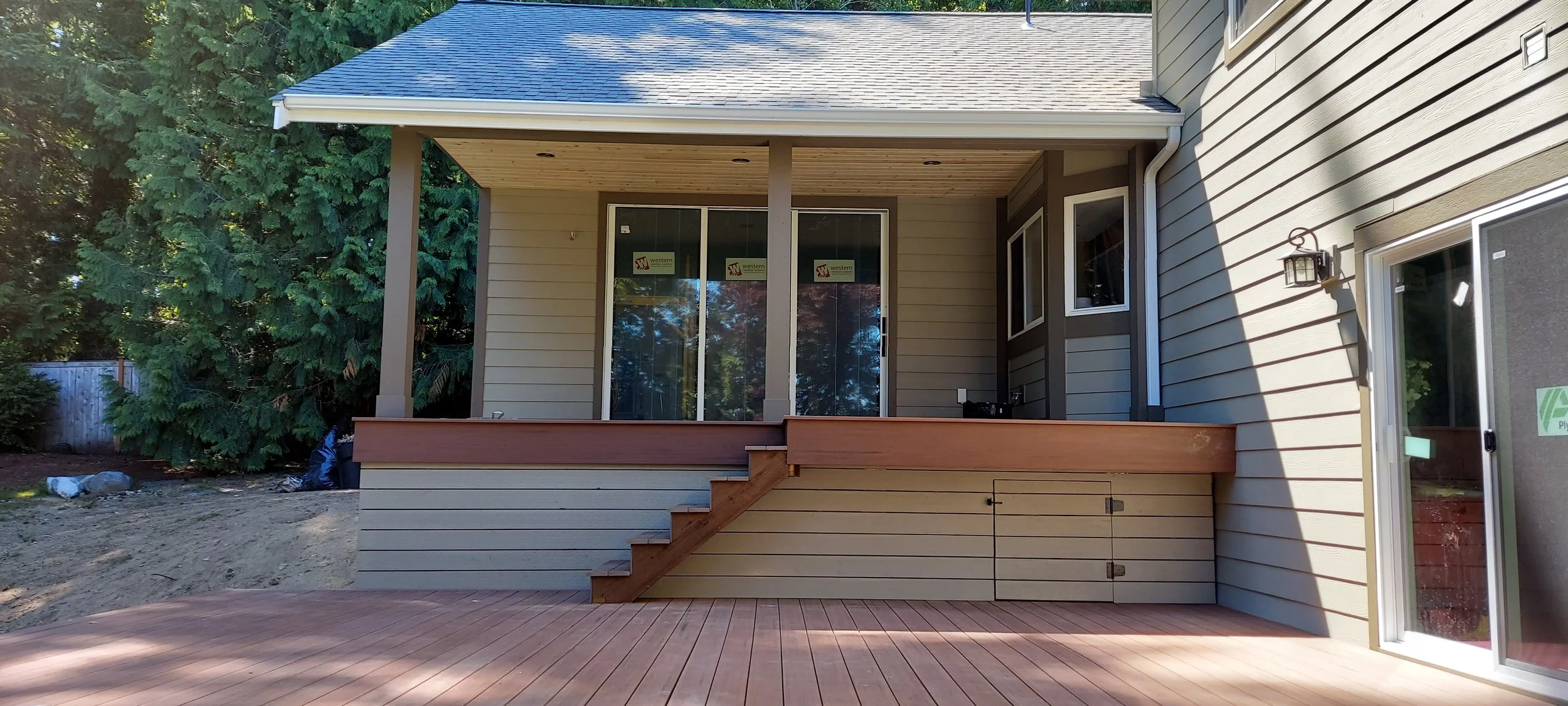 First floor addition with upper and lower deck and sliding doors.