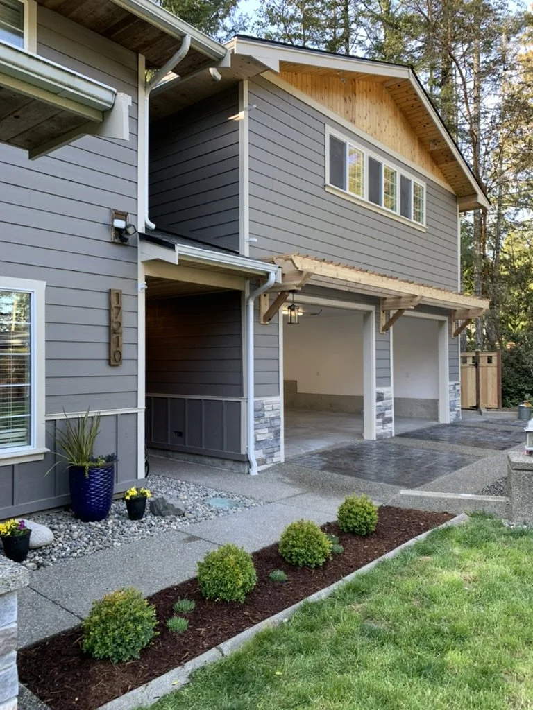 Home addition in Gig Harbor, WA with two-car garage and living space above.