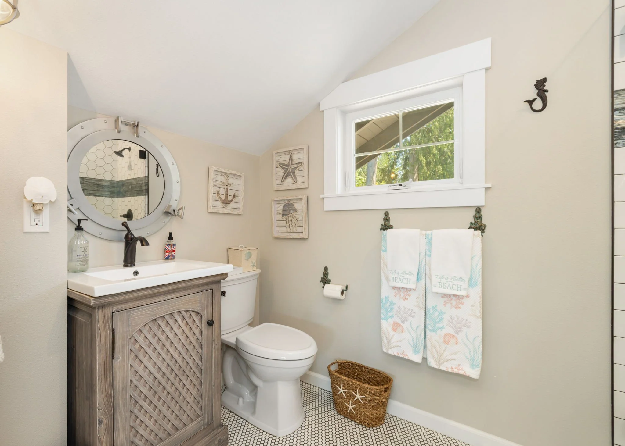 Nautical bathroom remodel in Lakebay, WA with stand-alone vanity and hexagonal tiled floor.
