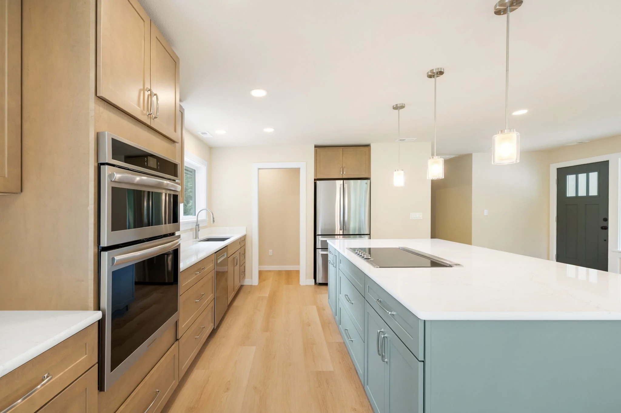 Kitchen remodel on Fox Island, WA with stainless appliances and island with rangetop.