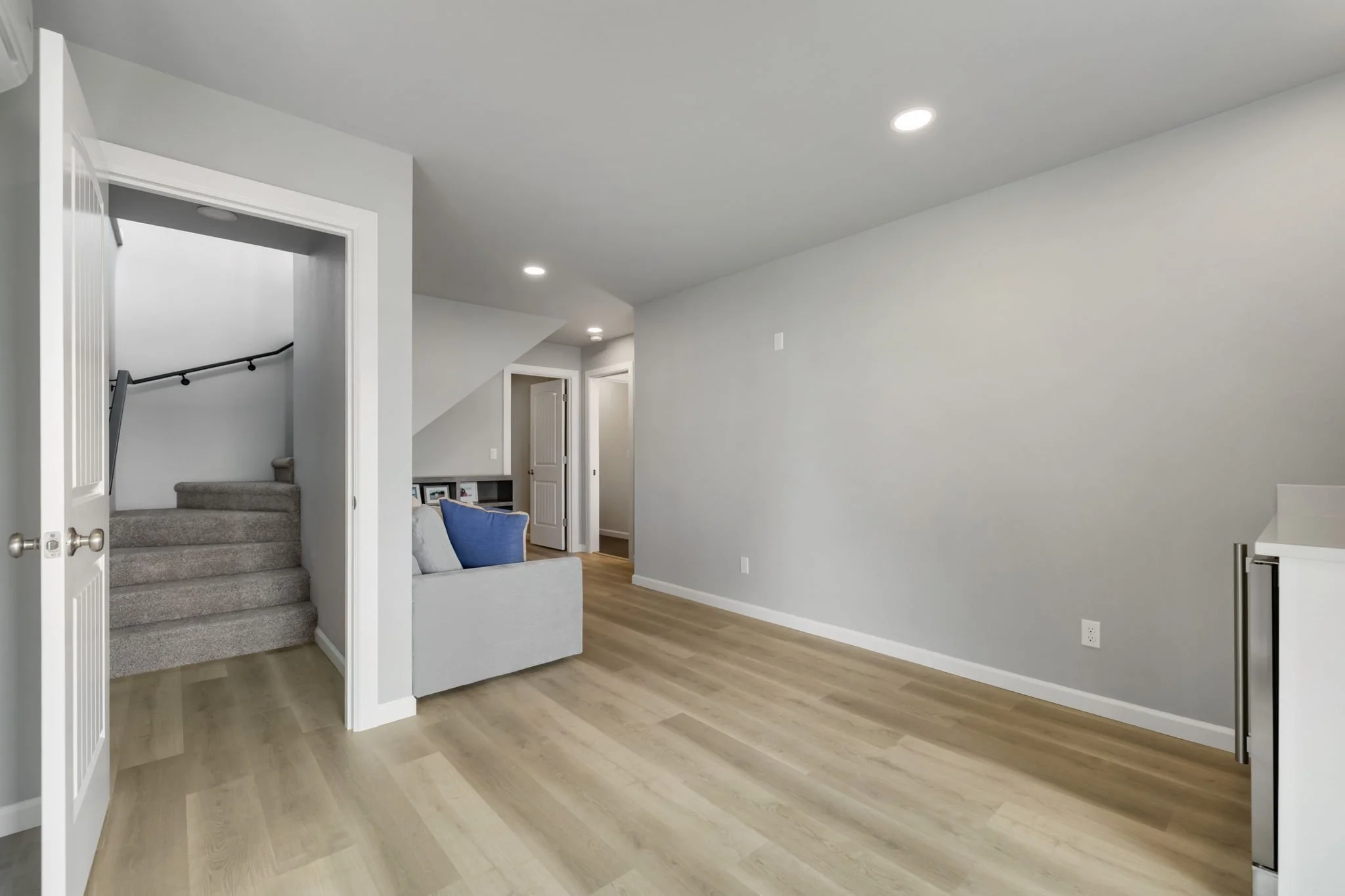 Daylight basement new construction with staircase and laminate flooring.