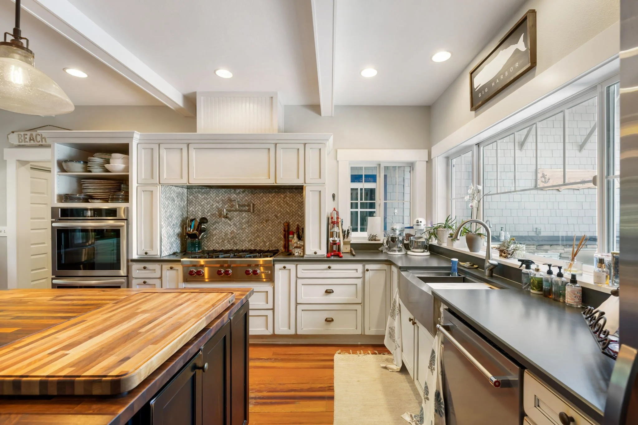 Beach cottage kitchen remodel in Lakebay, WA with butcher-block counters.