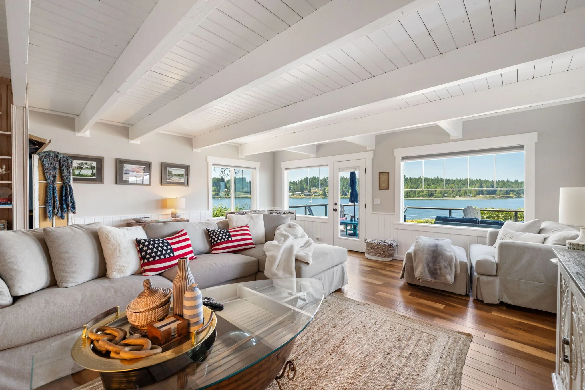 Lakebay, WA family room remodel featuring beam ceiling, water views, and vinyl flooring.