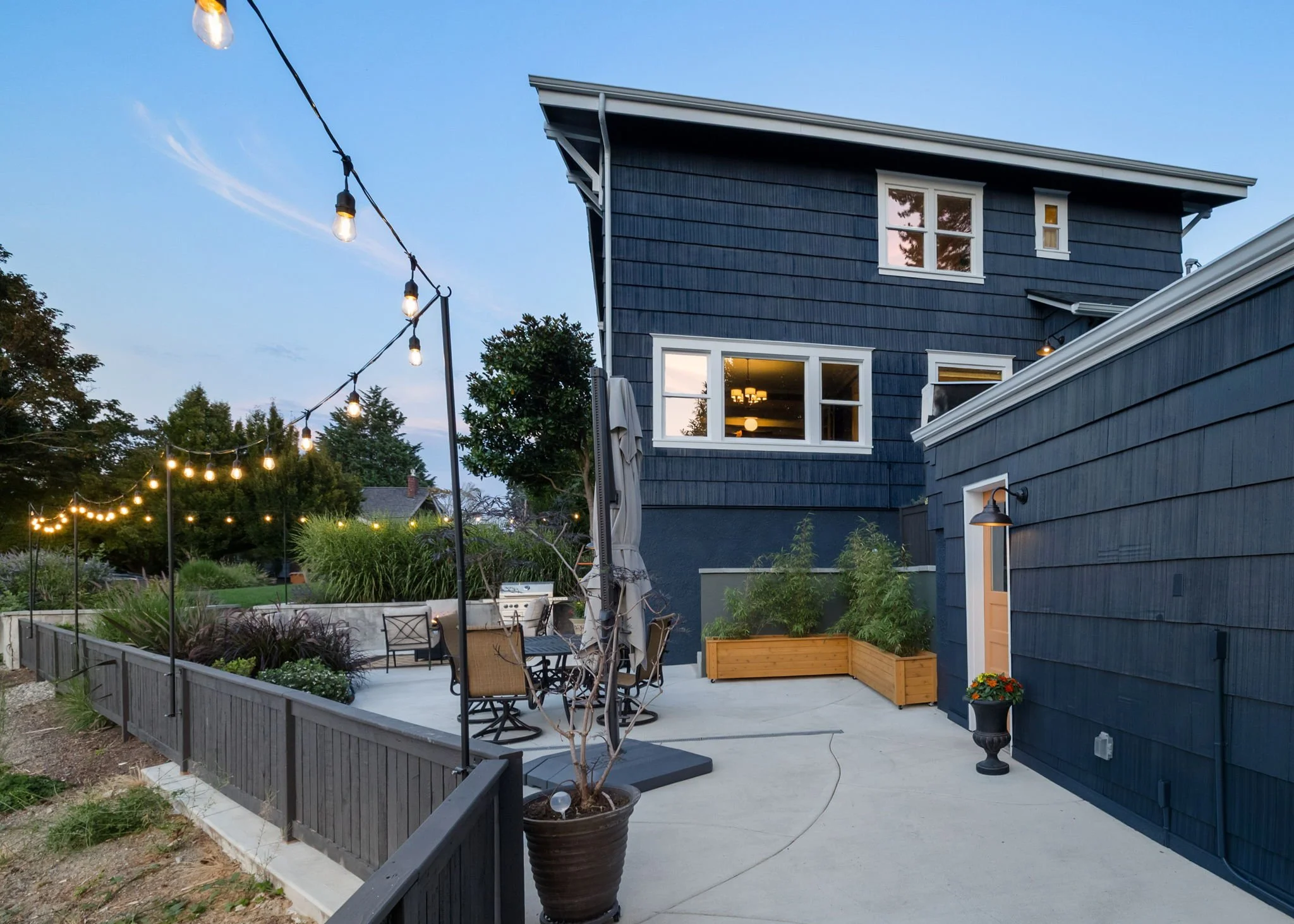 Custom deck and outdoor living space with evening lighting