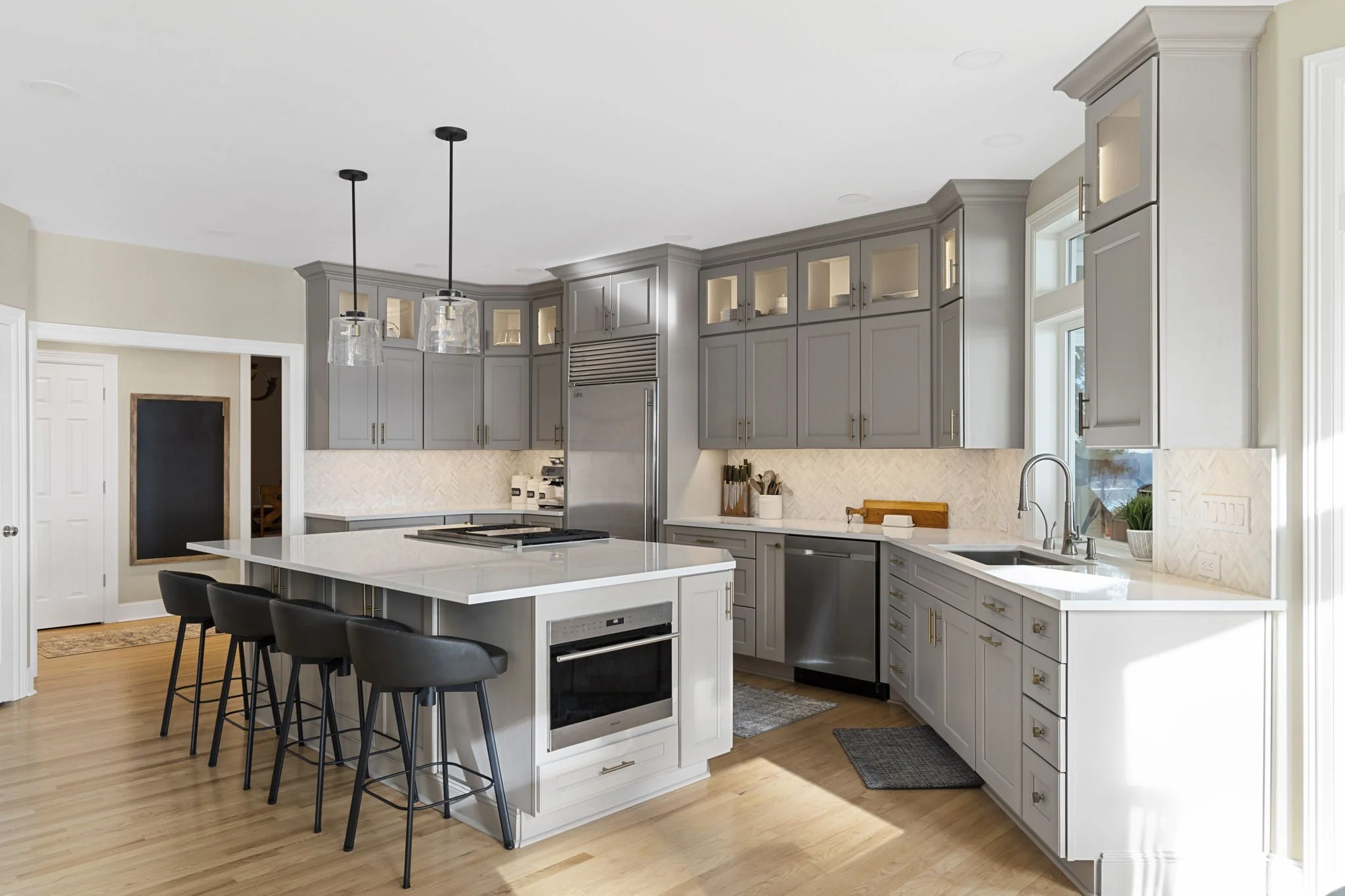 Kitchen remodel in Gig Harbor, WA with upper and lower cabinets, quartz countertops, and stainless appliances.