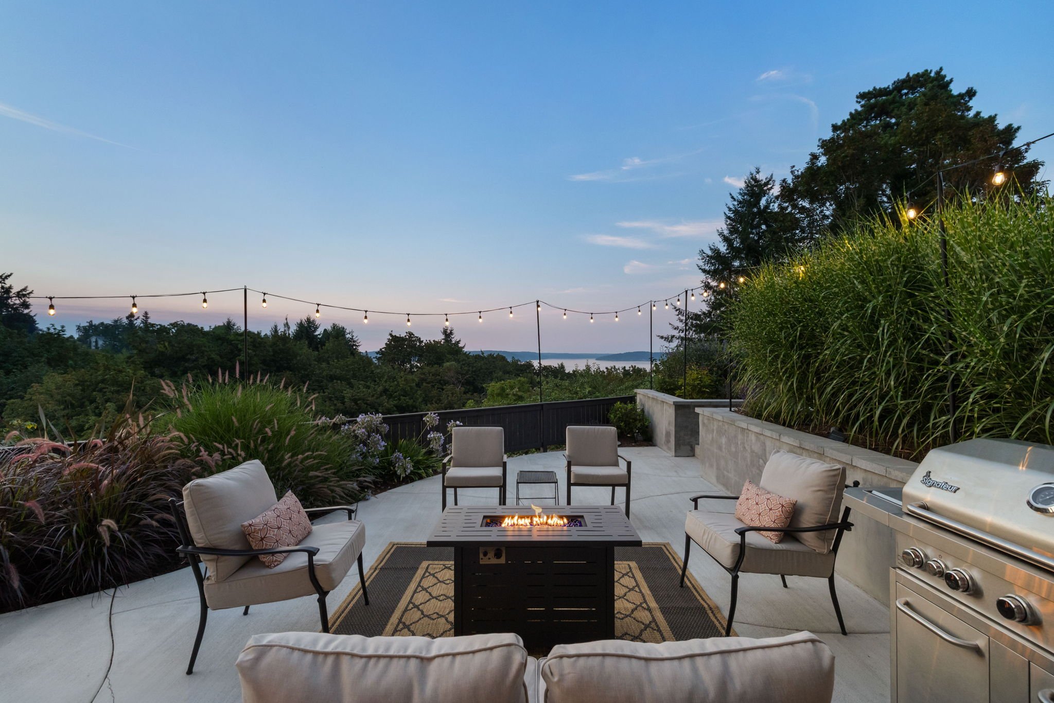 Custom deck and outdoor living space with evening lighting