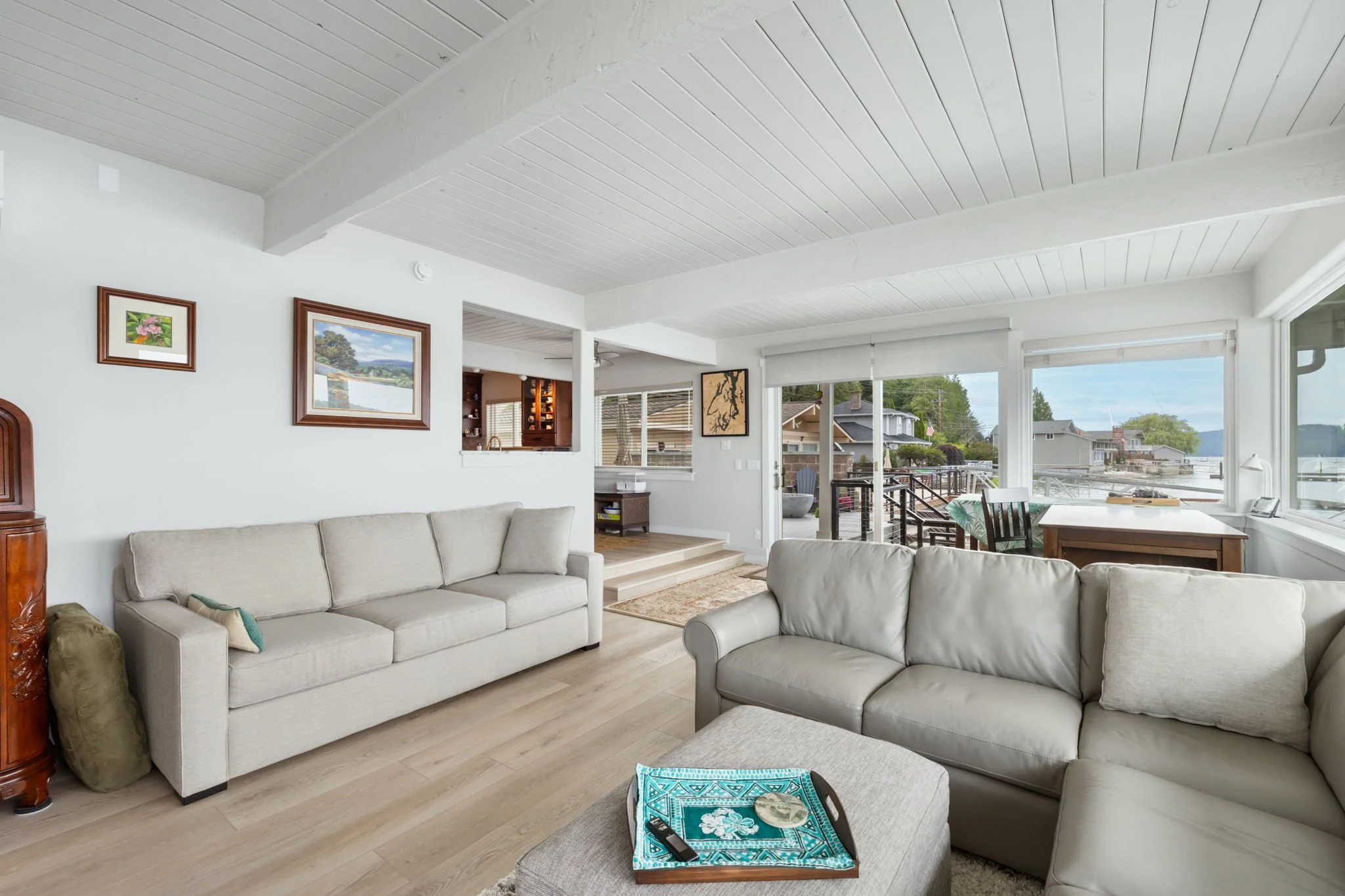 Home remodel in Belfair, WA with wooden beam ceiling and sliding doors onto deck.