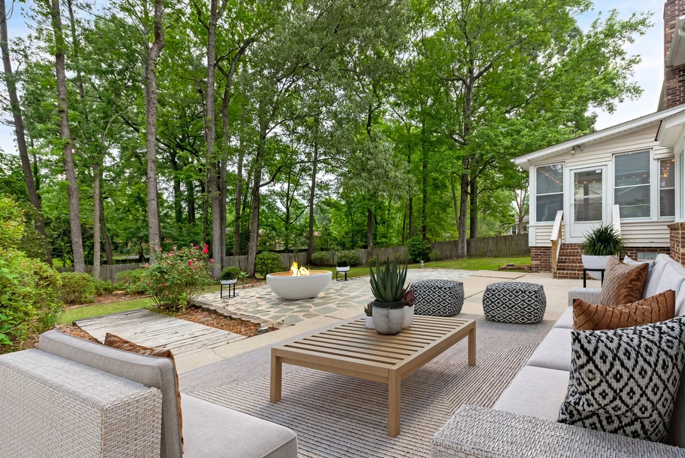 Backyard patio virtually staged with seating and fire pit