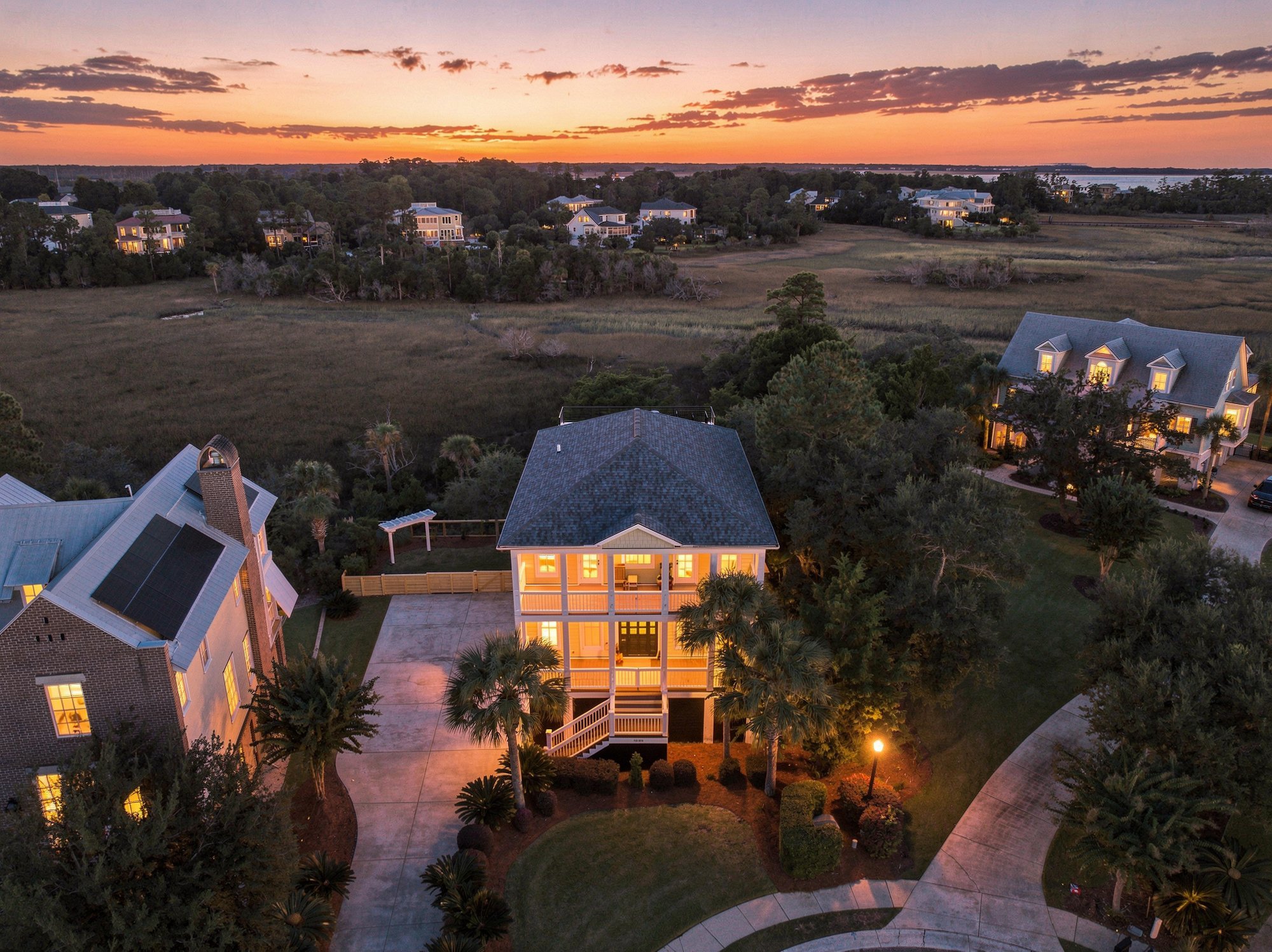 Twilight aerial of a home in The Point at RiverTowne, Mount Pleasant, with the marsh and the Wando River behind it
