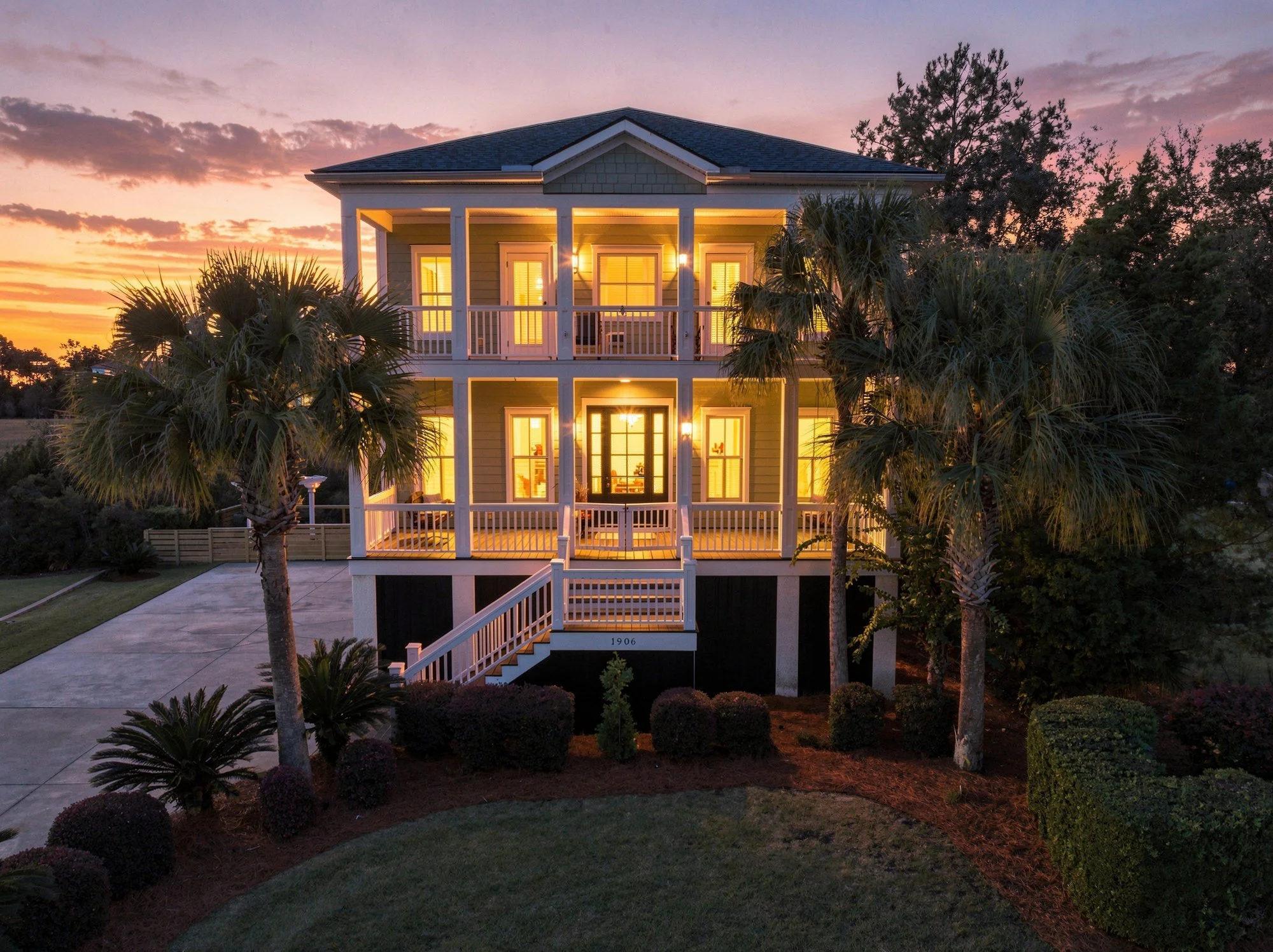 Twilight exterior with double porches lit, The Point at RiverTowne, Mount Pleasant SC