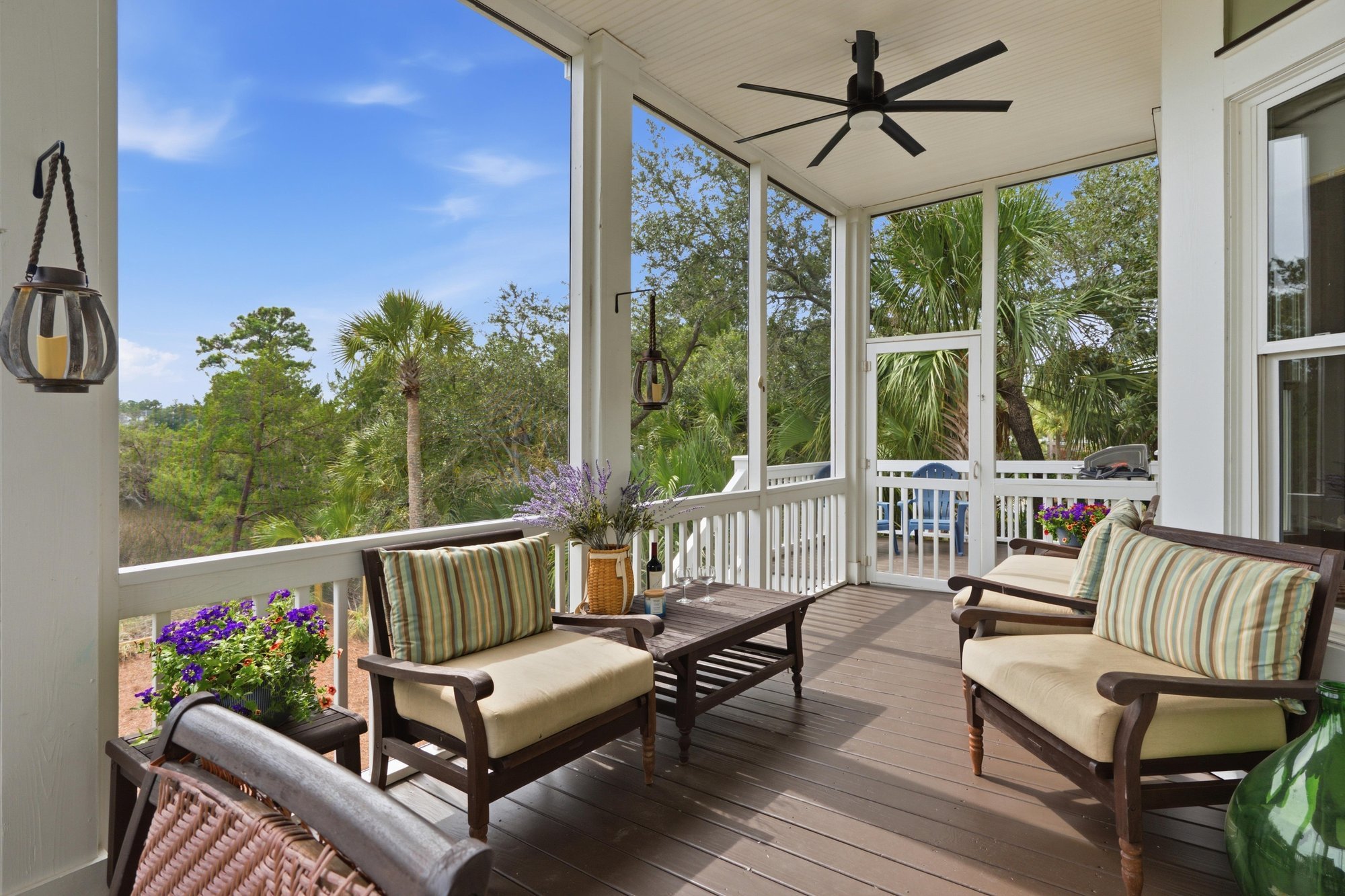 Screened porch with seating and marsh views in The Point at RiverTowne, Mount Pleasant