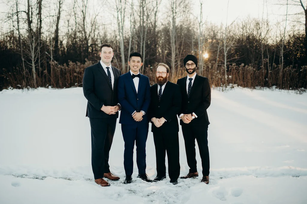  The groom and his groomsmen pose for a picture together. 