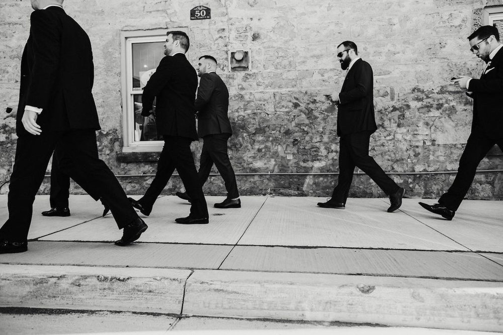  The groom and his groomsmen walk to the wedding. 