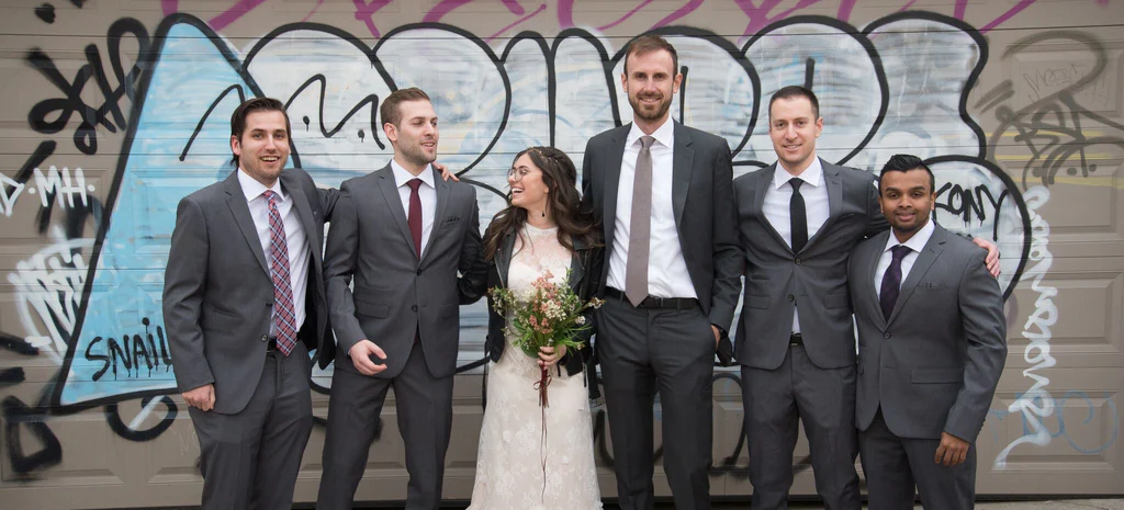 The groomsmen posing for a picture with the bride.
