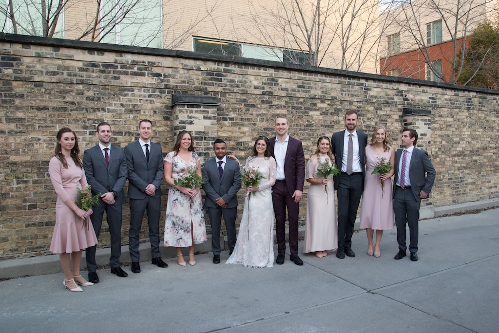 A wedding party poses for a photo on Queen St West in Toronto.