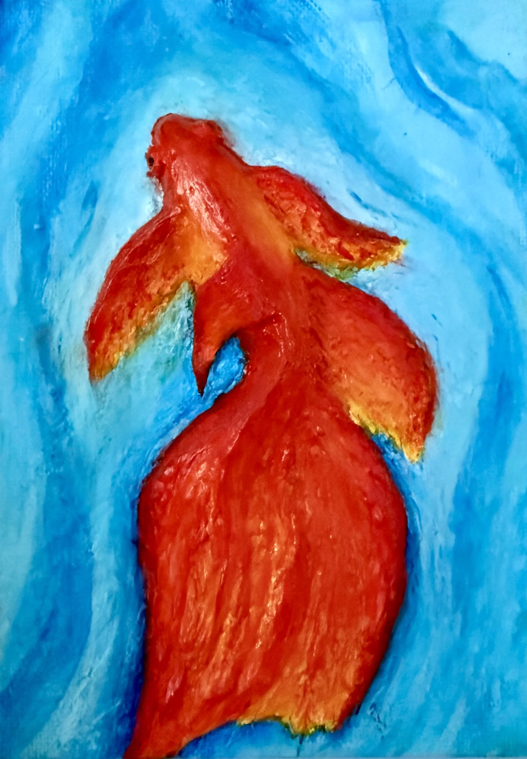 Close-up of the textured orange and red brushstrokes on a goldfish art print.